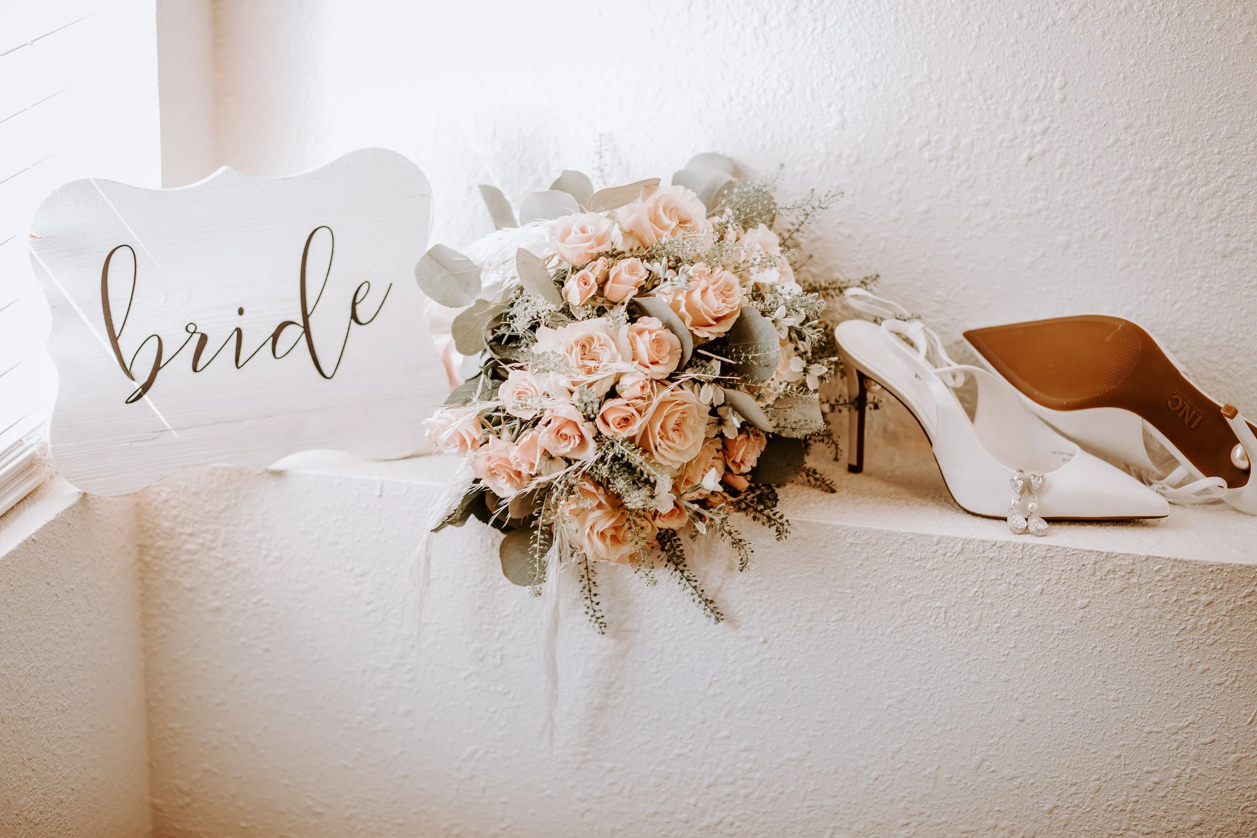 bride sign bouquet and heels