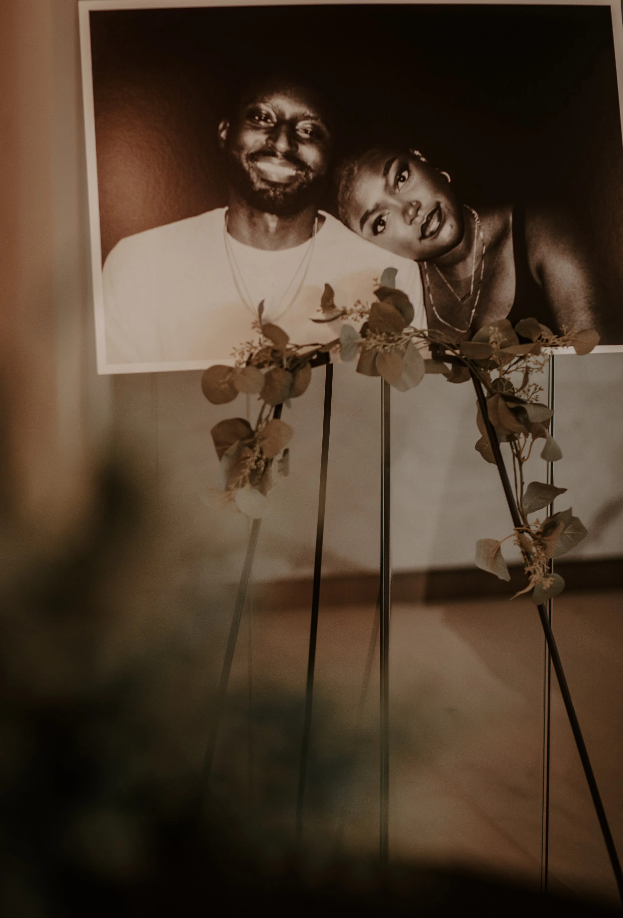 man and woman in photo on stand