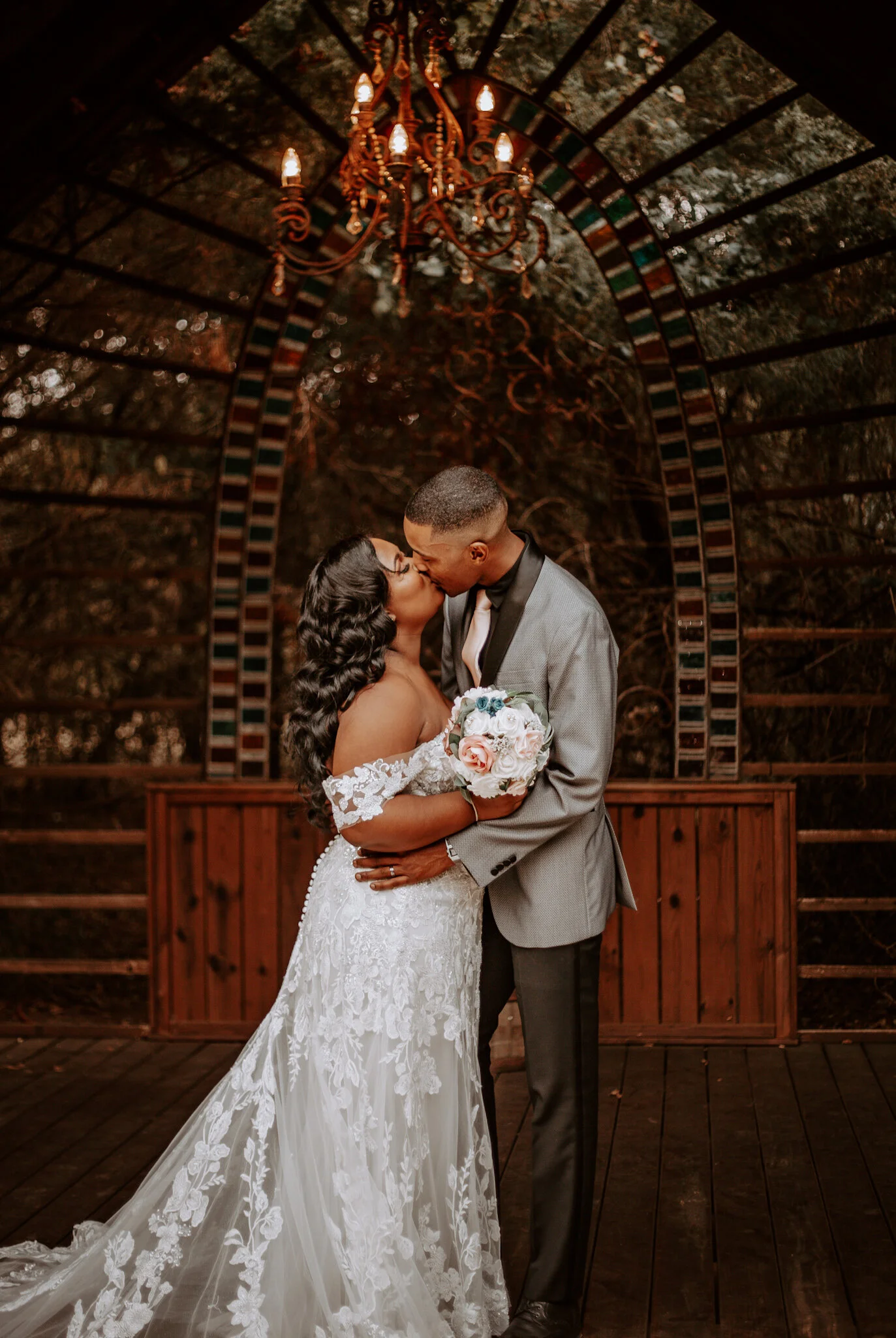 man and woman kissing at altar