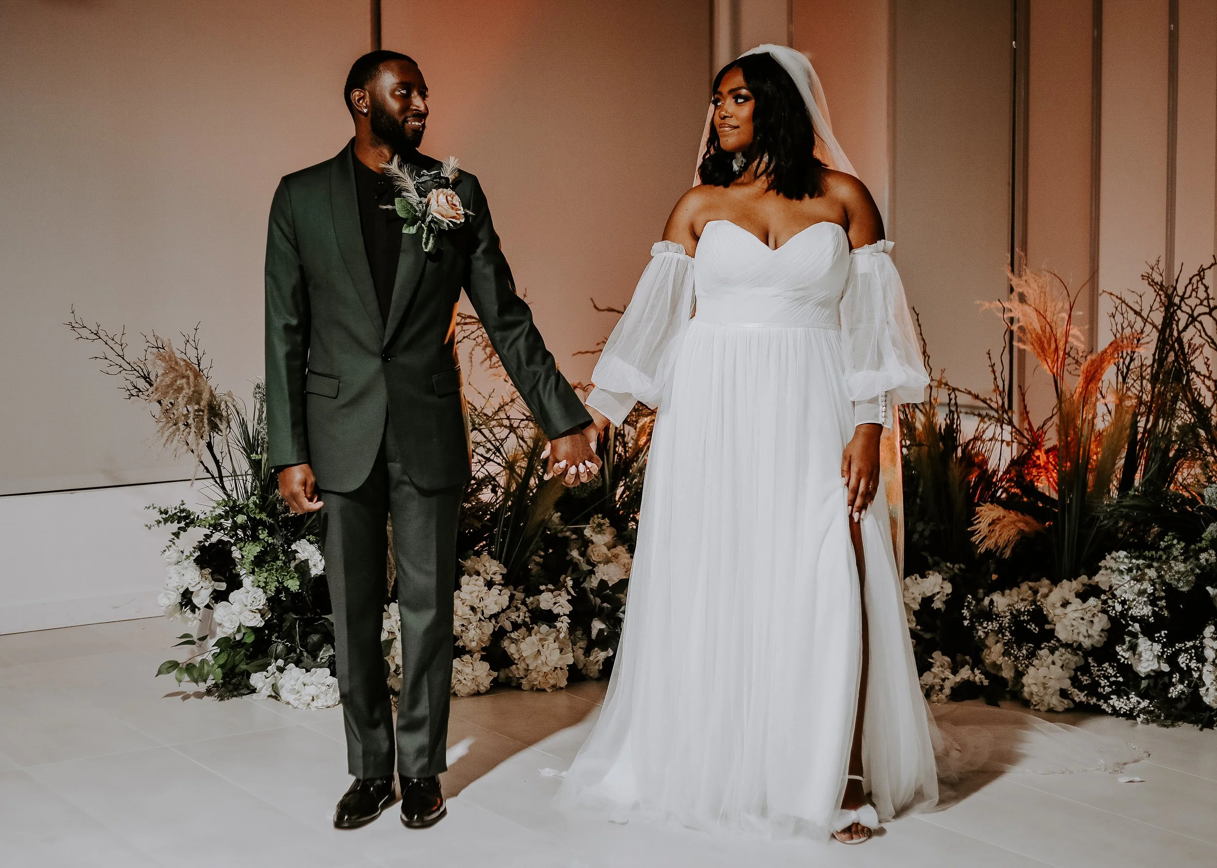 couple holding hands looking at each other