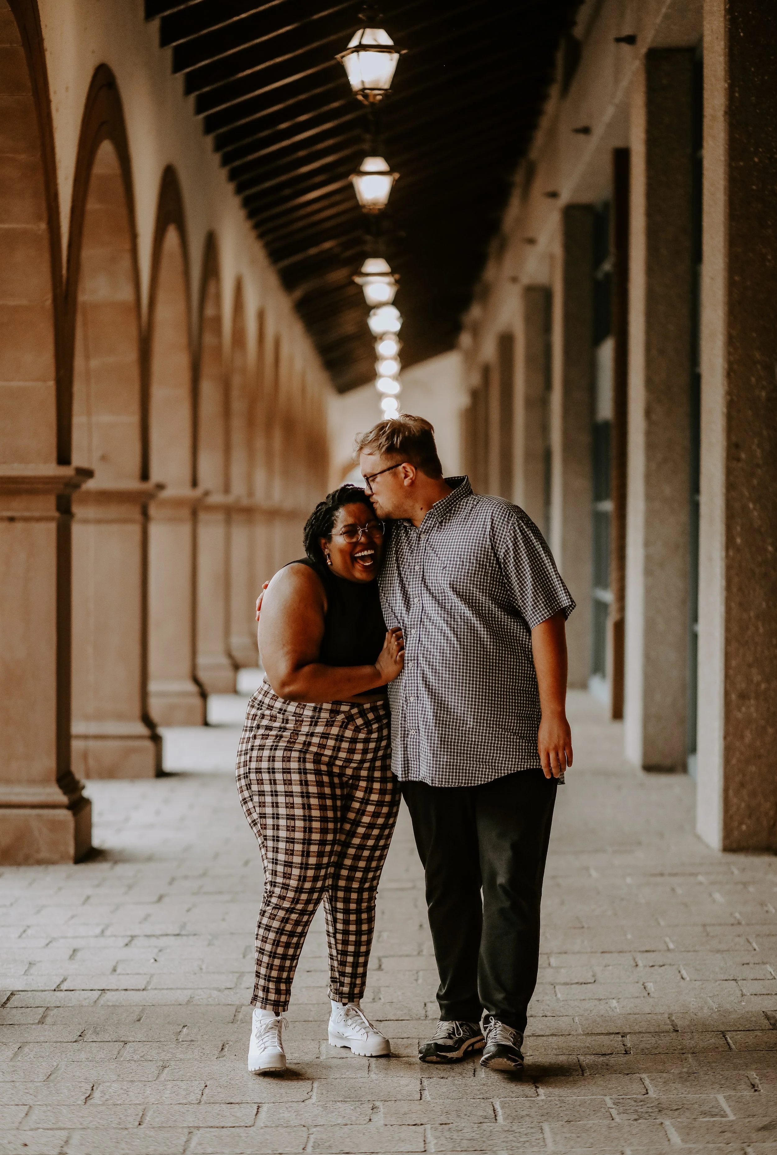 man giving woman kiss on forehead and walking