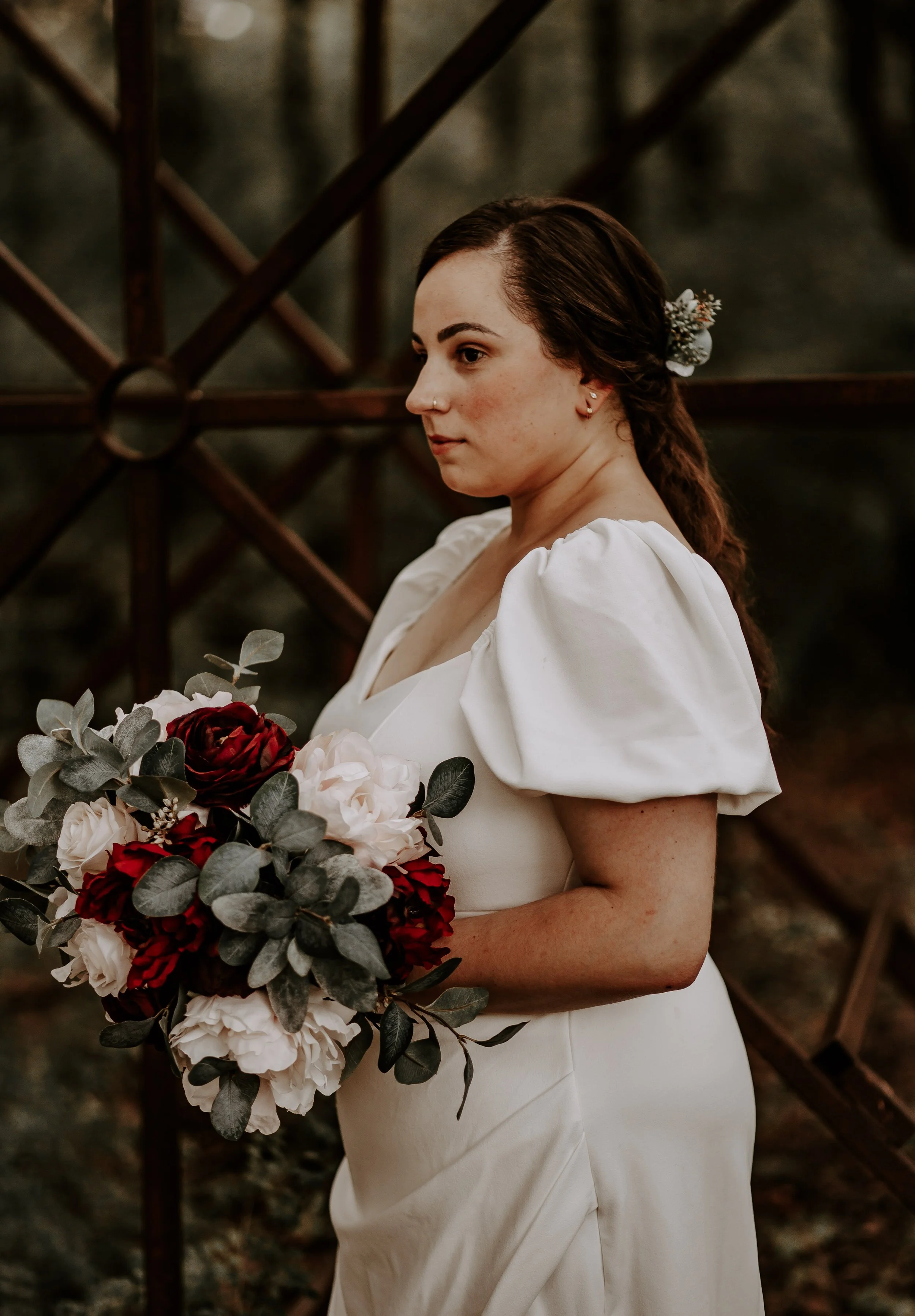 woman looking away from camera holding bouquet