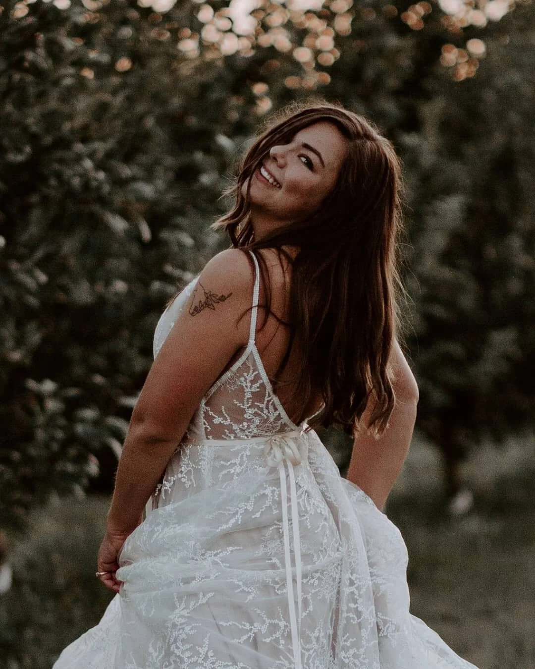 woman looks over shoulder with hair in face
