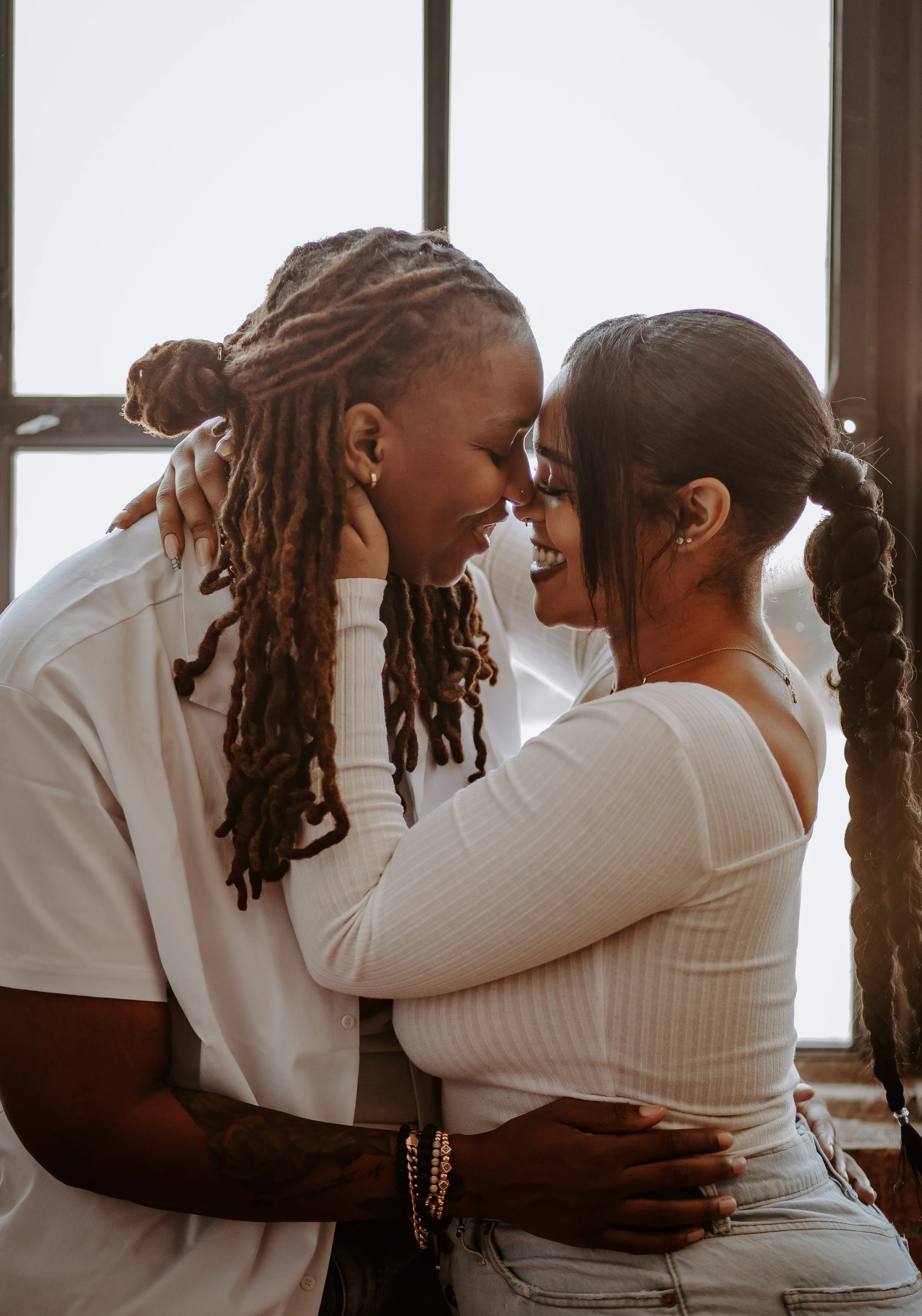 couple hugging while smiling at each other