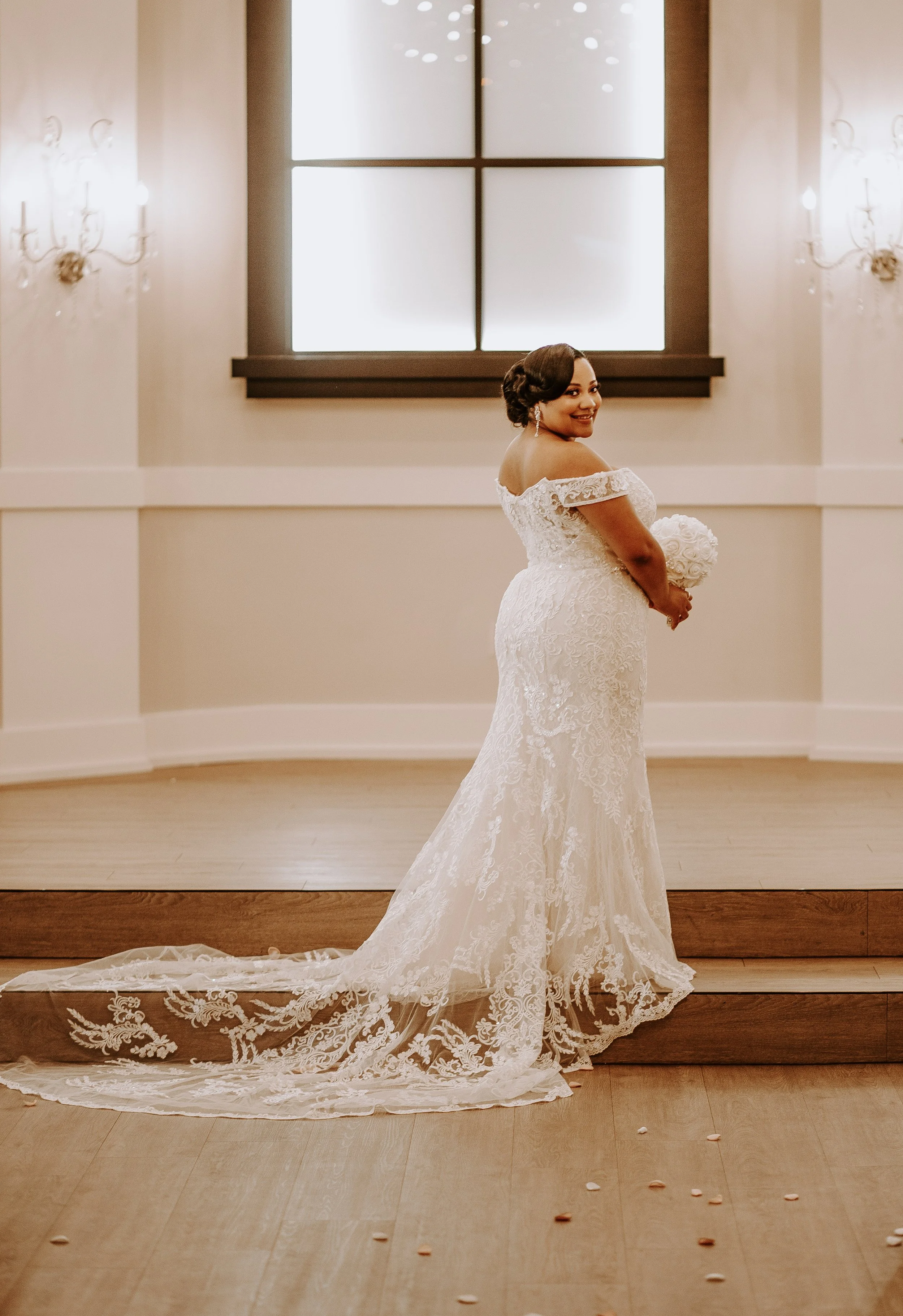 woman with long wedding train holding bouquet