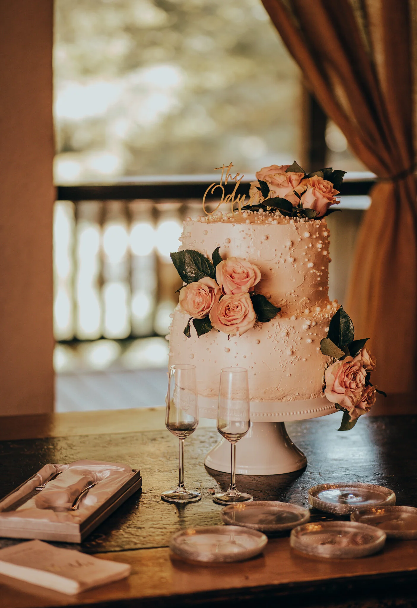 Cake and wine glasses in front of window