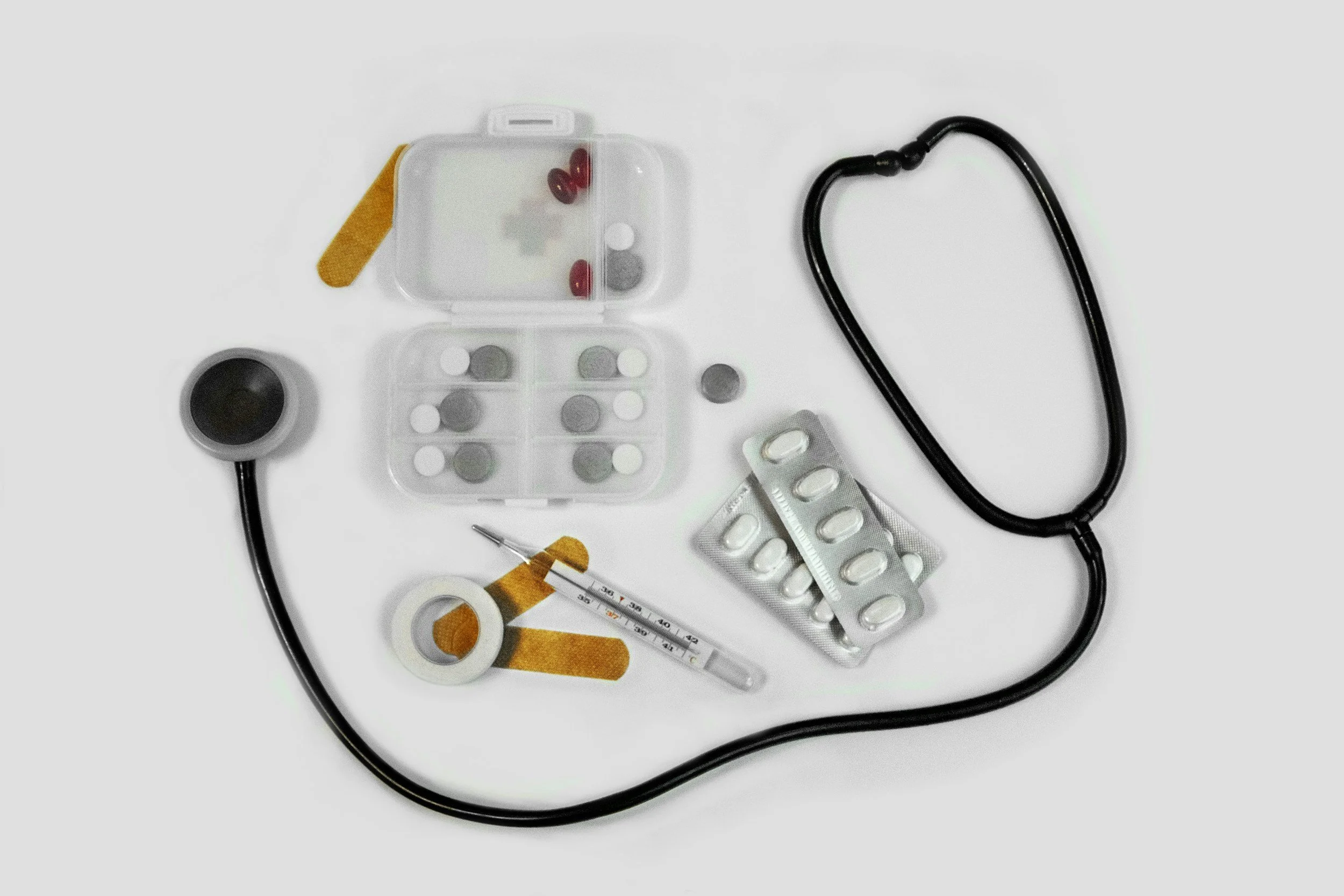 An image showing a stethoscope, pills and various medical doctor tools