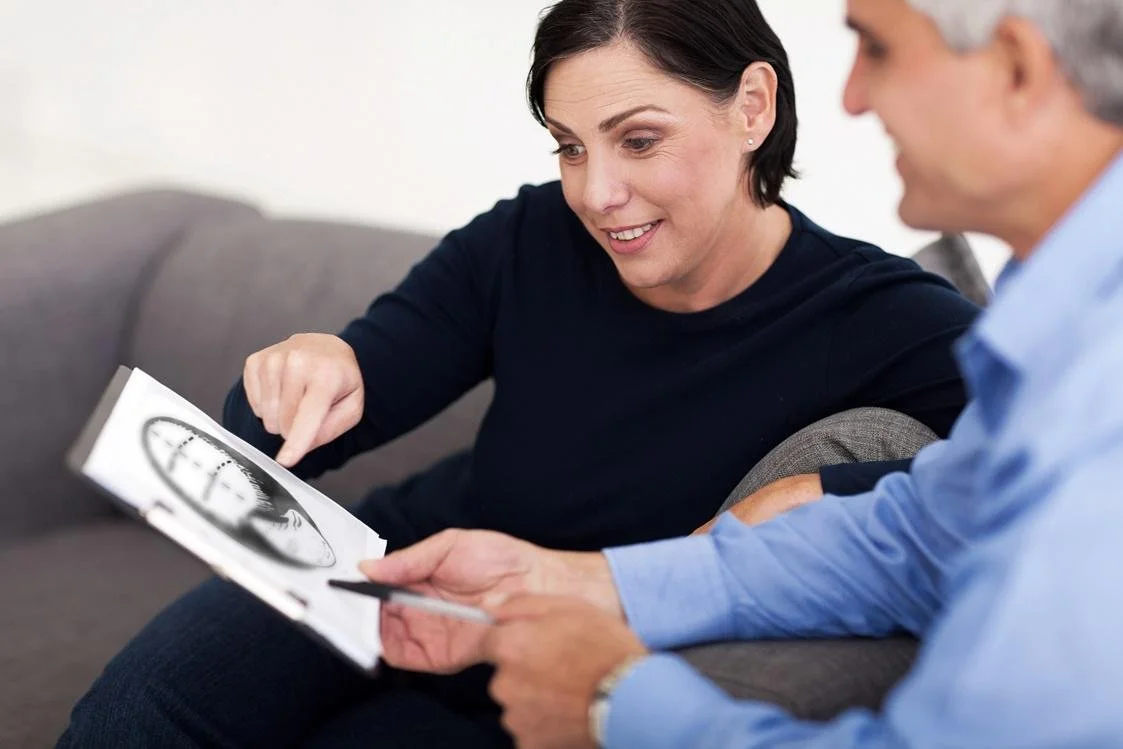 An image of a doctor guiding a patient through a hair loss consultation.