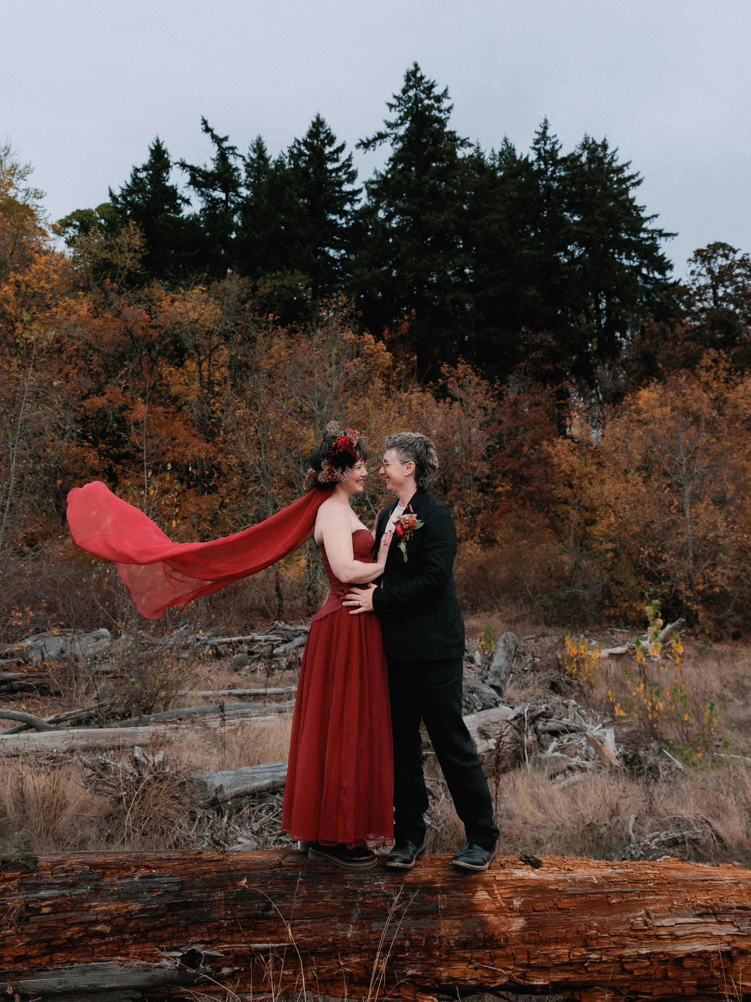 Newly wed couple posing for portraits after their elopement ceremony along the willamette river