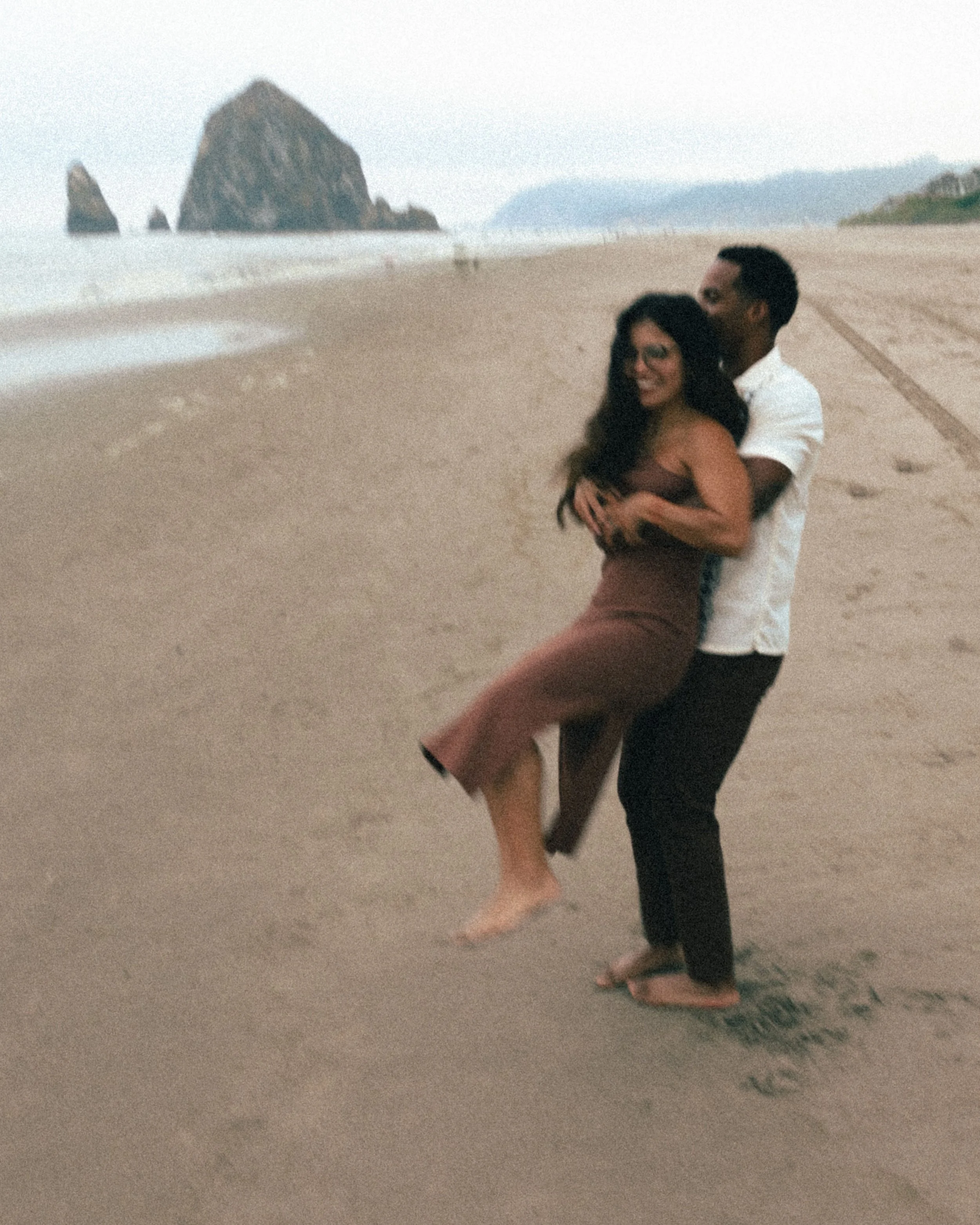 Couple laughing during their Cannon Beach engagment session by Abigail Janelle Photography