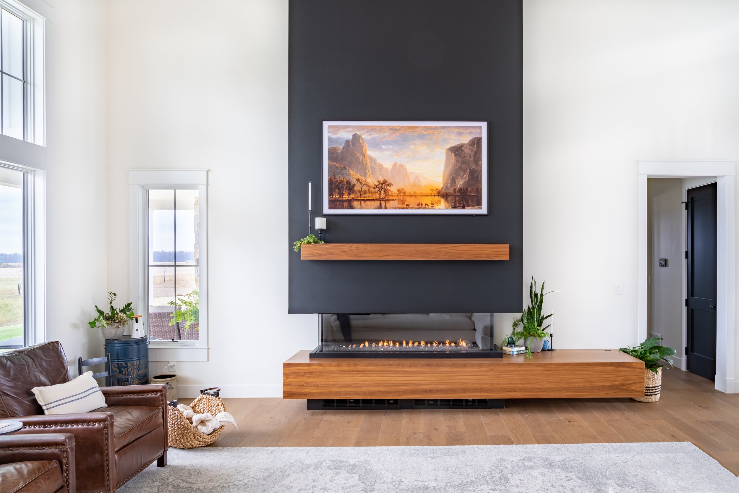 interior photo of a new living room with fireplace and TV