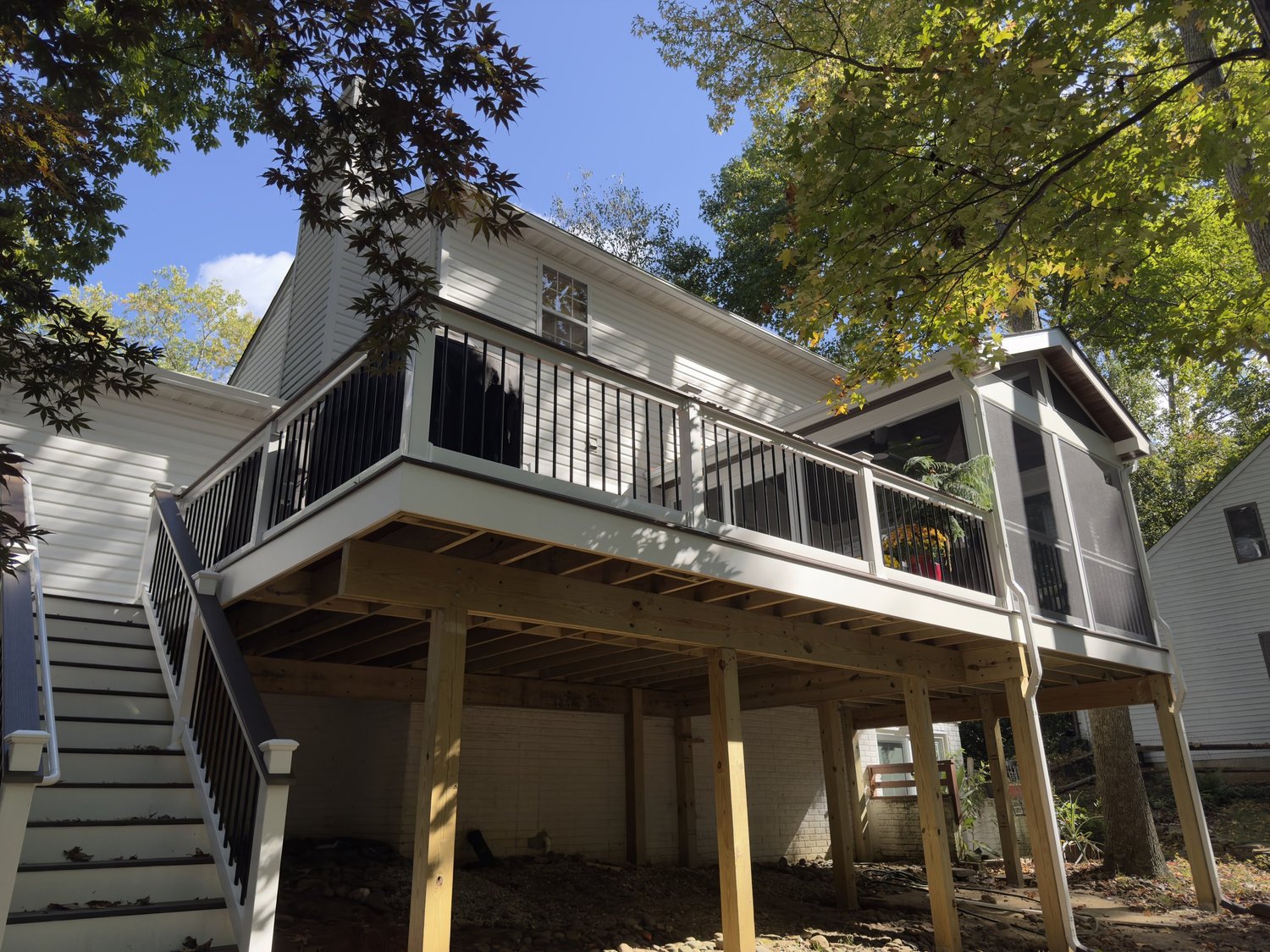 Updated deck stairs with white risers, dark treads, and clean railing details