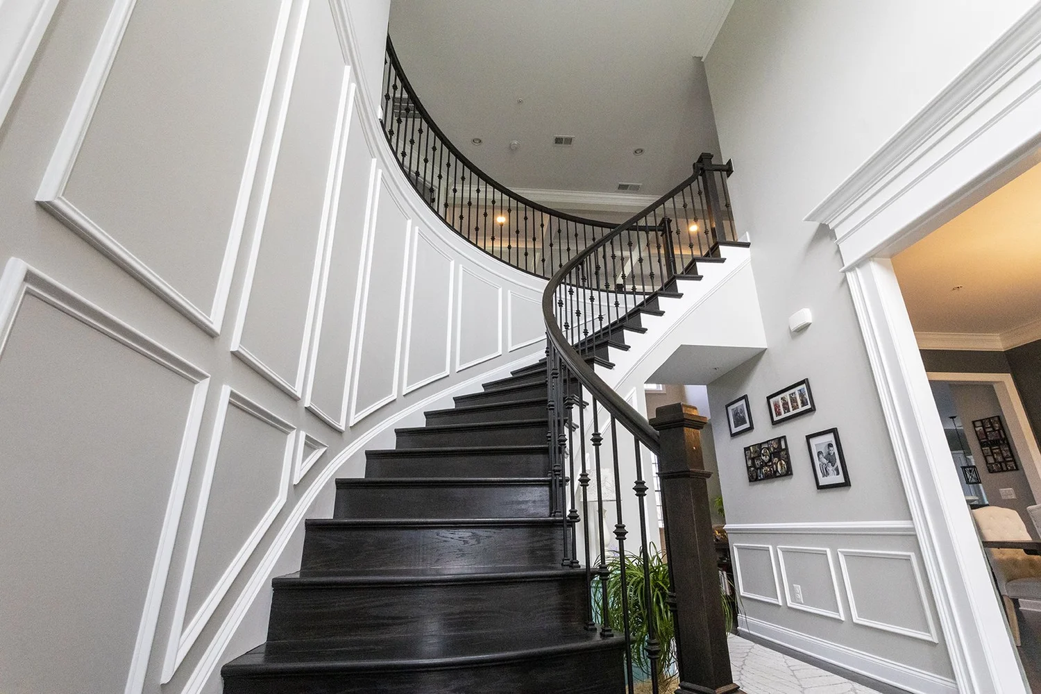 Open sight line from foyer into living room with coffered ceiling