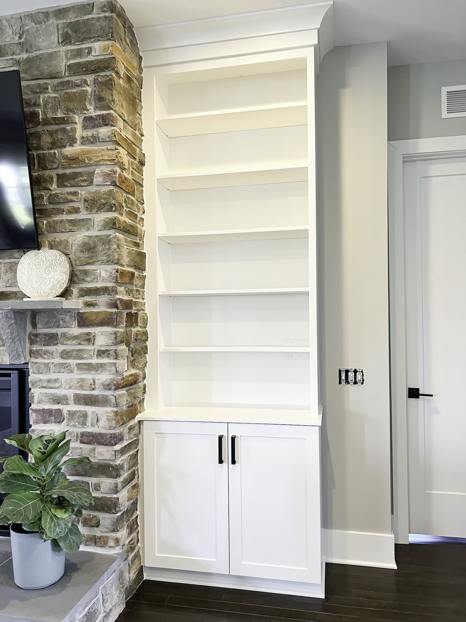 Custom white built-ins around a stone fireplace in Baldwin Maryland