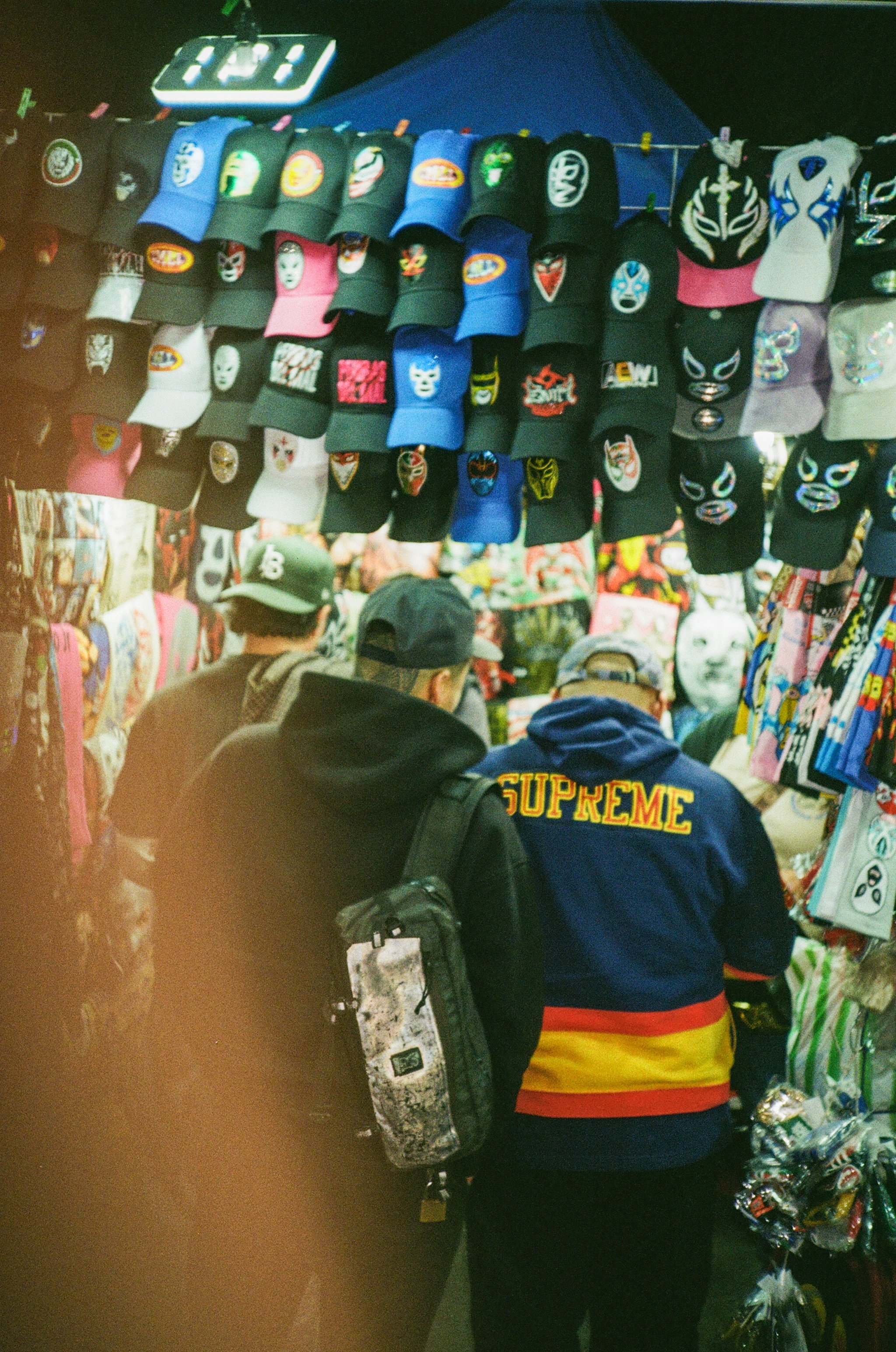Perusing the merch outside the luchas. My finger makes an ugly appearance. 