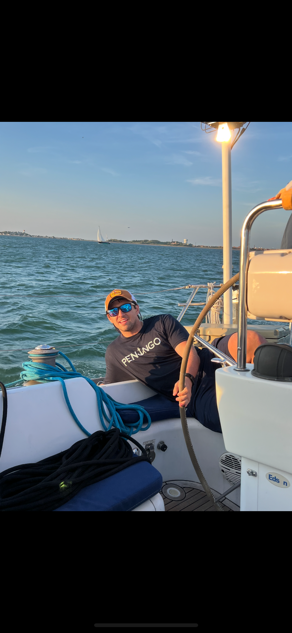 Deckhand Chris Hanley, at the helm while rocking some Peningo Merchandise.