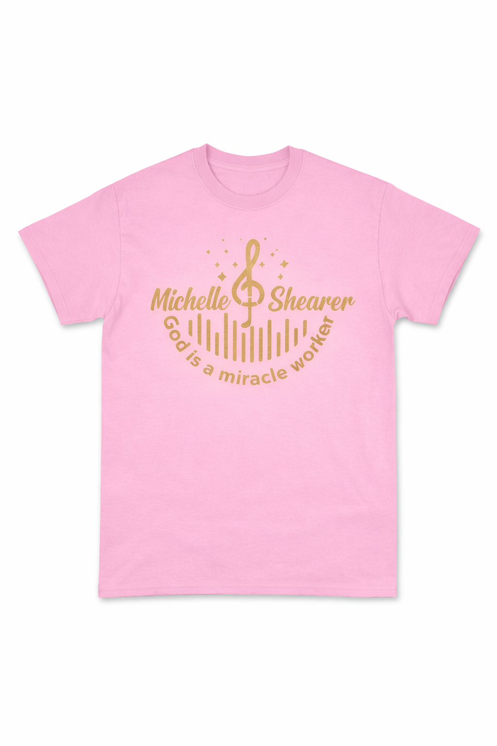 Pink “God is a miracle worker” t-shirt by Michelle Shearer with gold design displayed on white background
