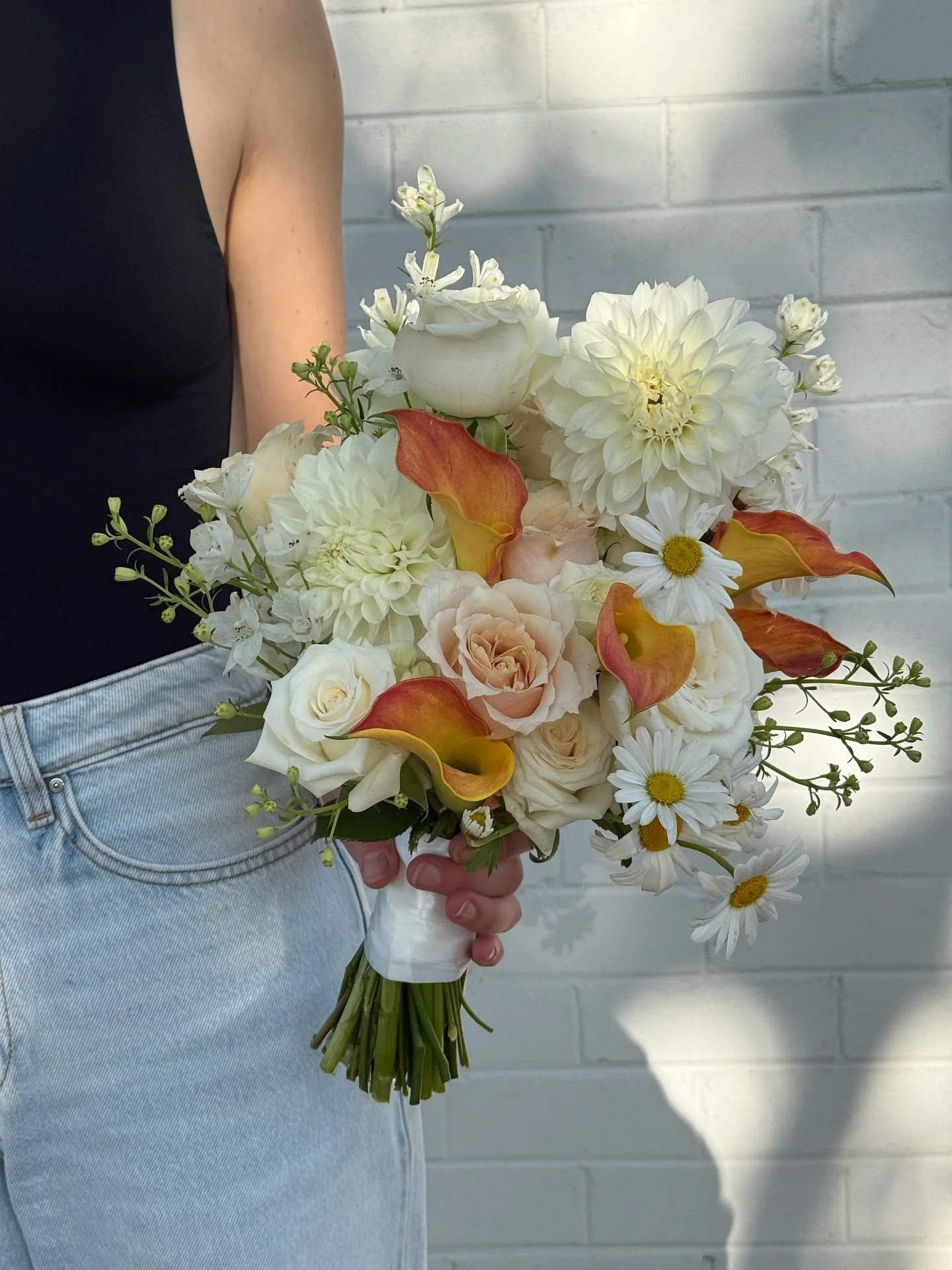 This bouquet was for our bride Fadzai 
⠀⠀⠀⠀⠀⠀⠀⠀⠀
A luxe combination of white seasonal blooms with a pop of rusty orange to suit her bridesmaids dresses.