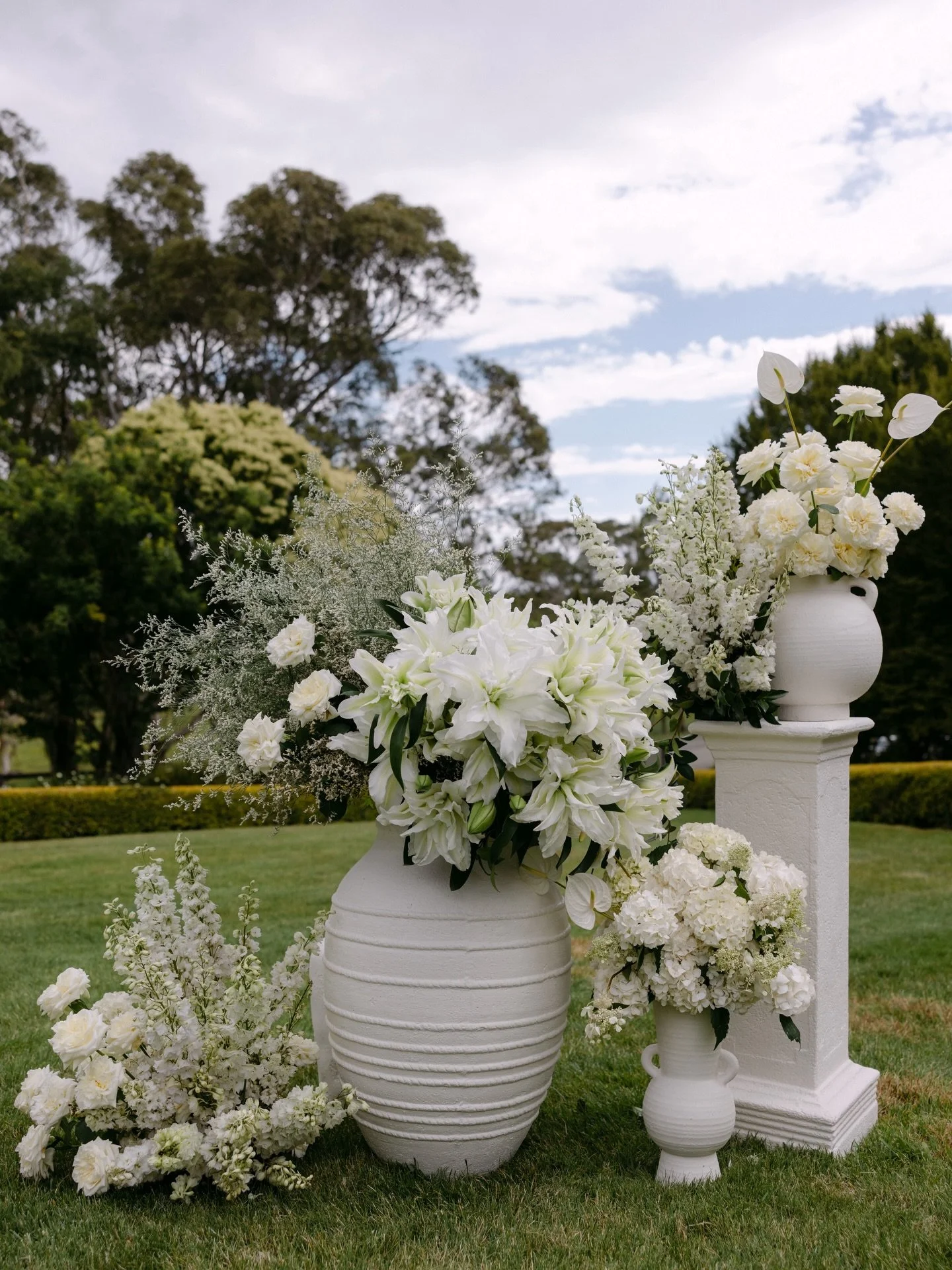 I &amp; L | the Ceremony 
A timeless mix of plinths and pots with white and green hydrangeas, roses, lillies, delphinium and anthuriums. The perfect backdrop in the tear drop at @cvrestaurant