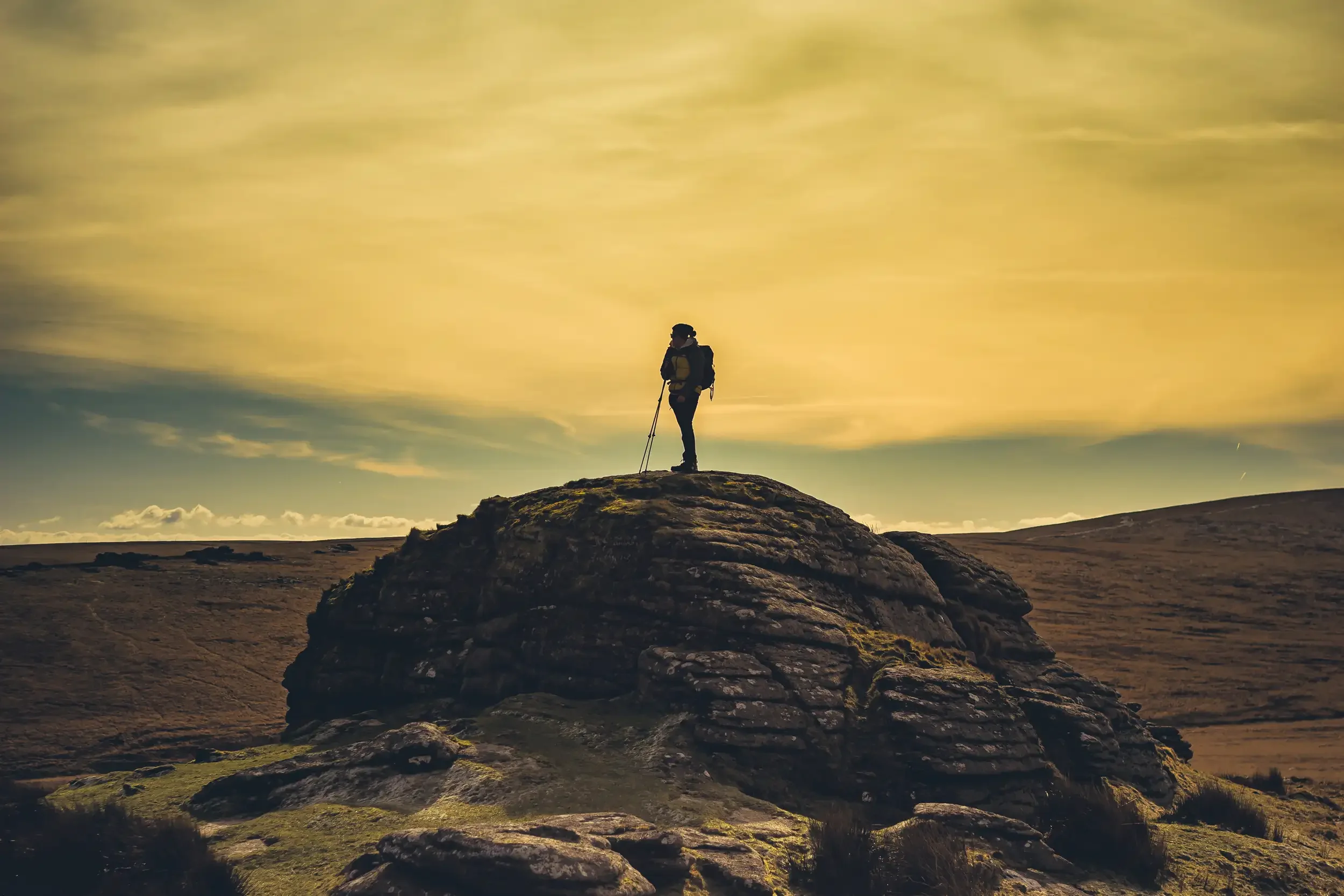 A hiker on top of Steeperton Tor on Dartmoor