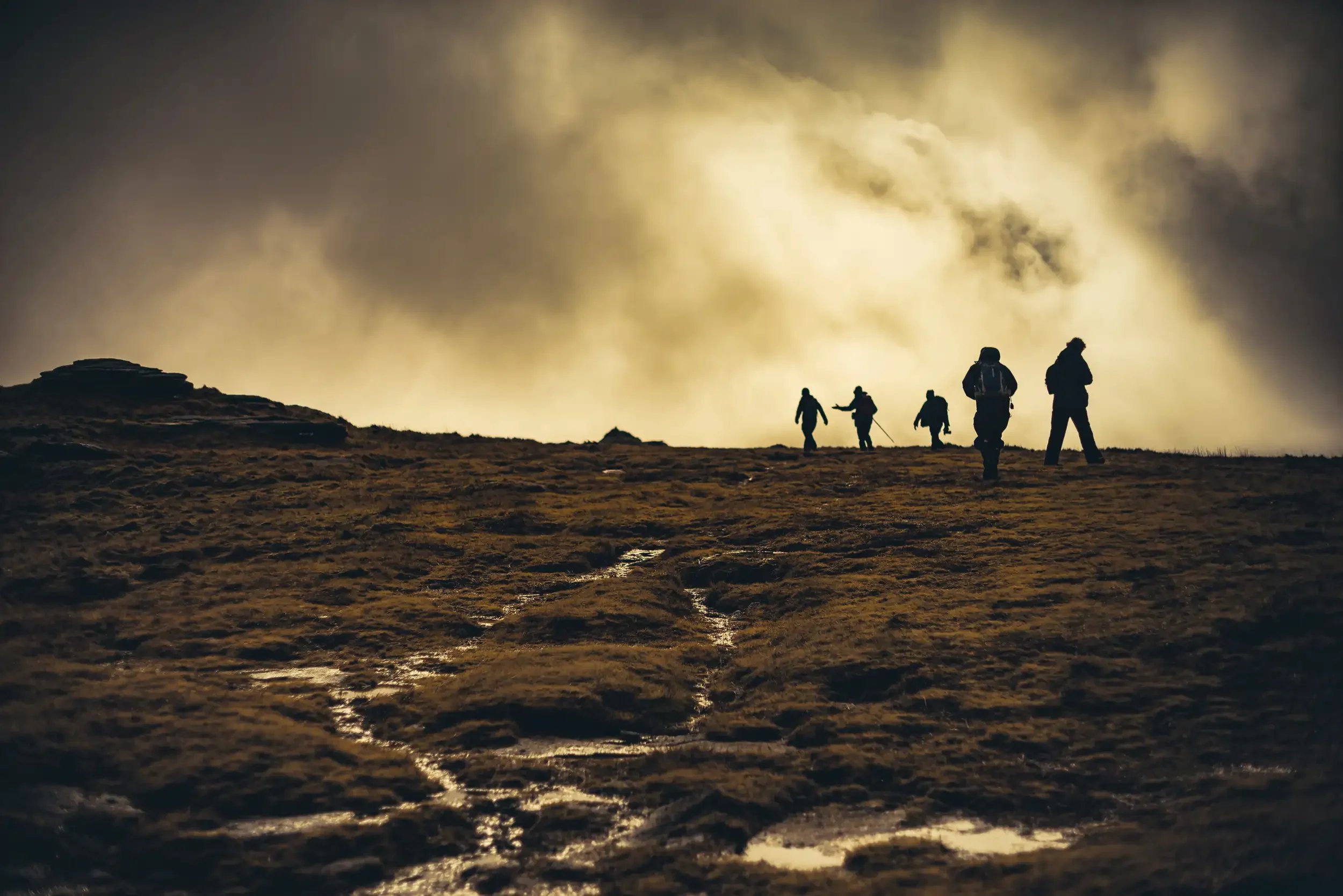 A group of hikers reaching the top of High Willhays on Dartmoor - The highest peak on the moor