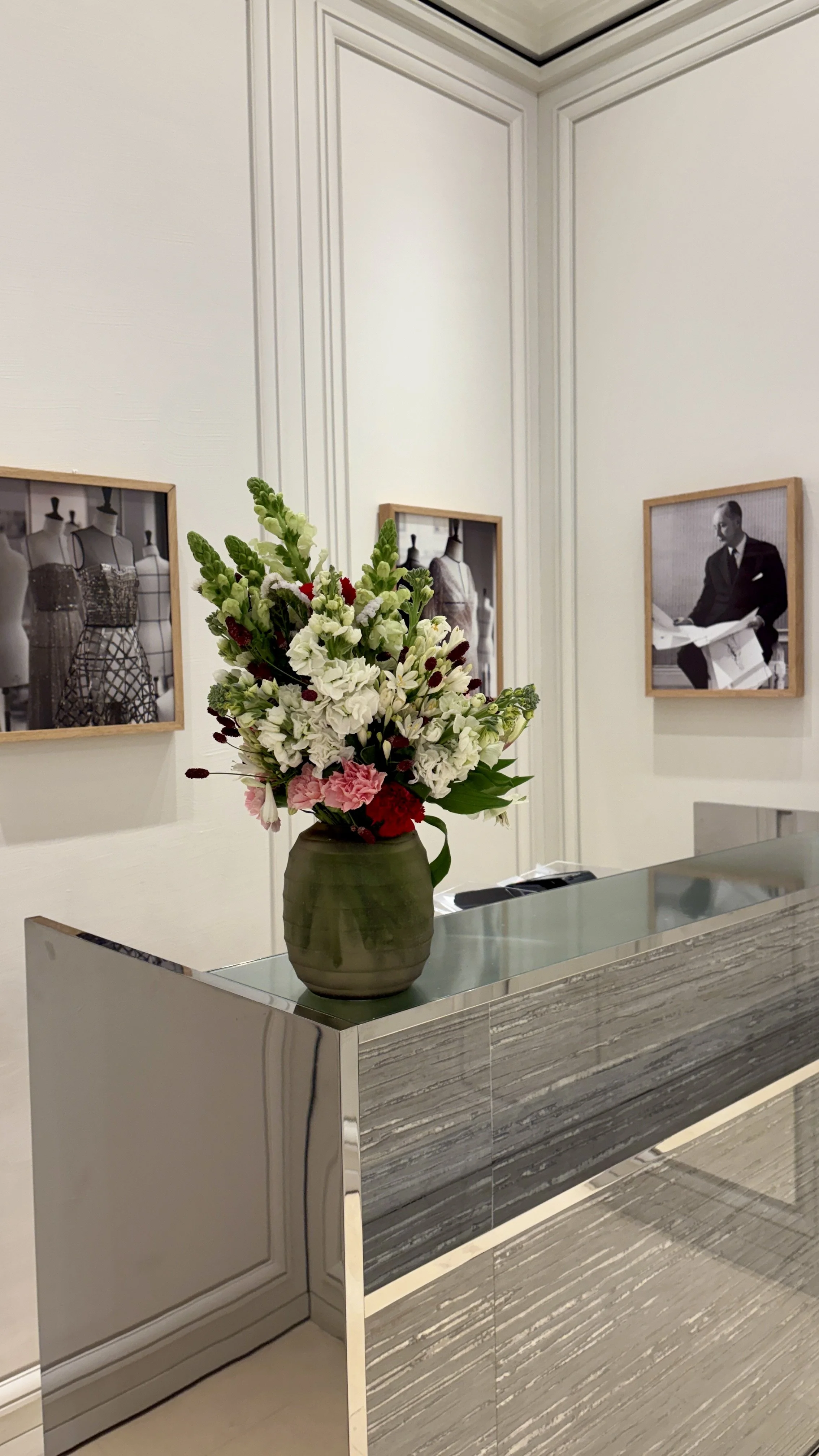 Weekly floral display enhancing the interior of a luxury fashion flagship store with elegant seasonal flowers and modern styling
