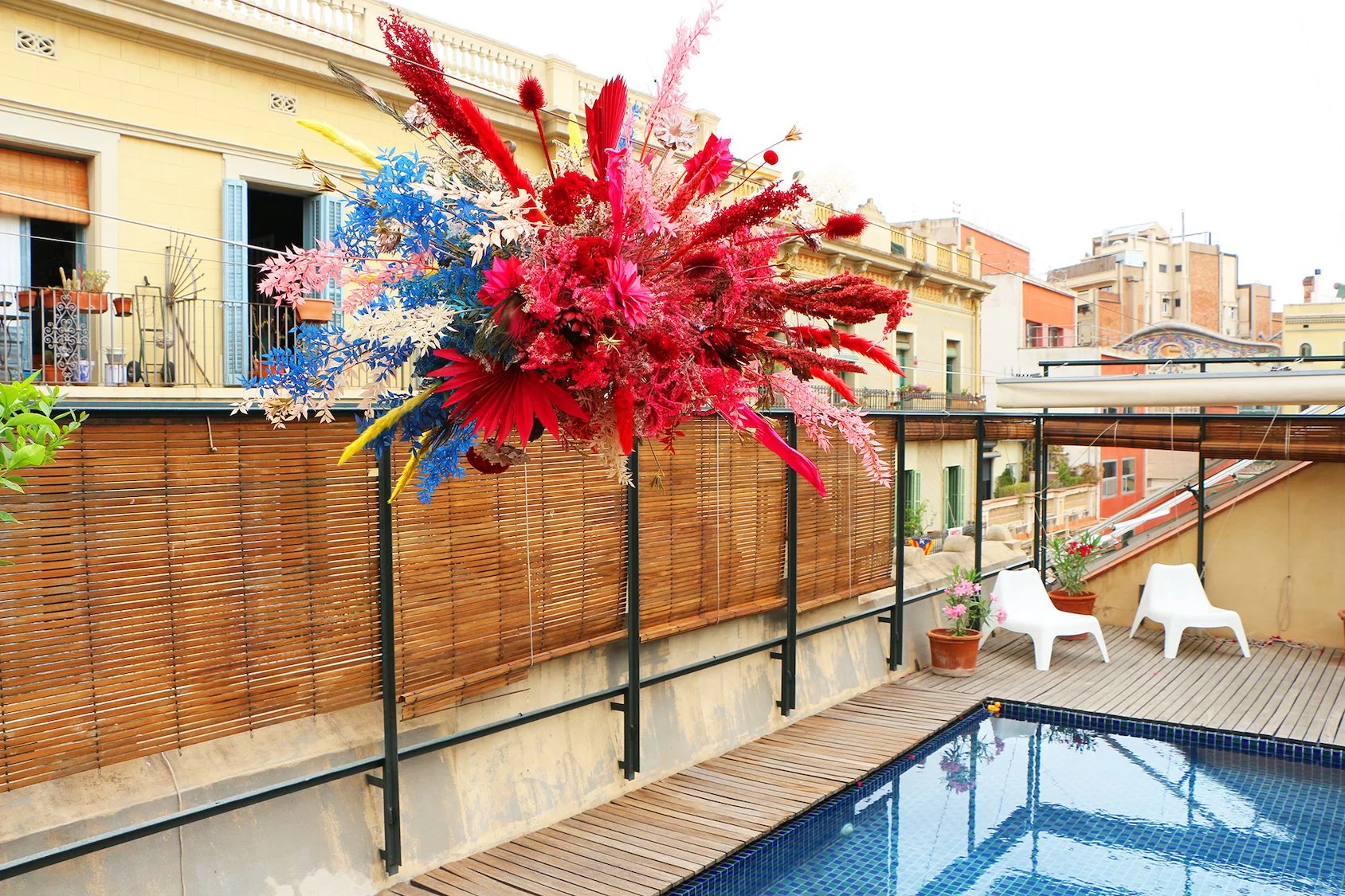 Luxury floating floral sculpture by Mosaic above a rooftop pool in Gràcia, Barcelona, for high-end events and international brands