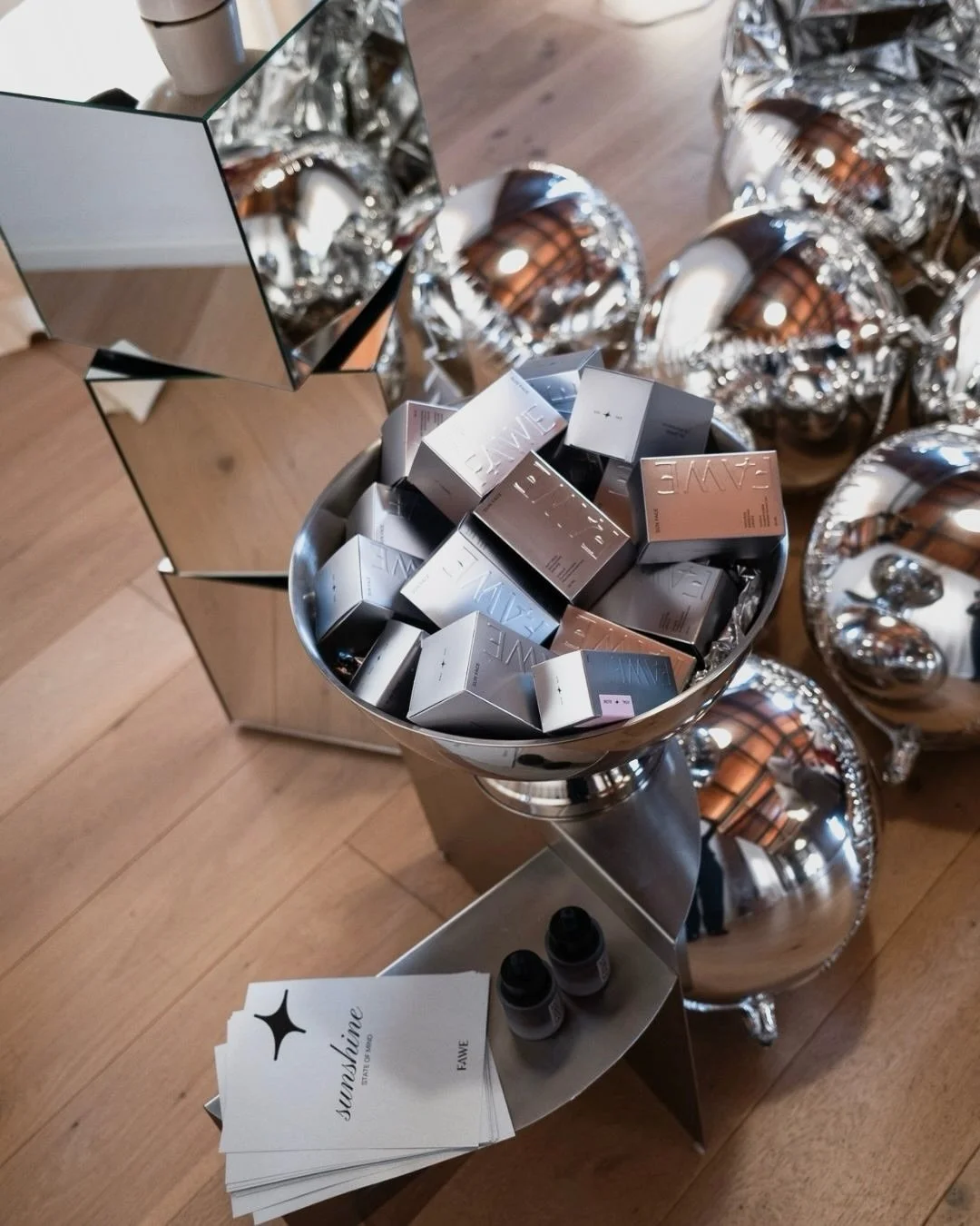 Guests attending the FAWE PR event surrounded by sculptural floral compositions made with black Cordyline leaves, creating a refined and contemporary luxury atmosphere at Juno House Barcelona
