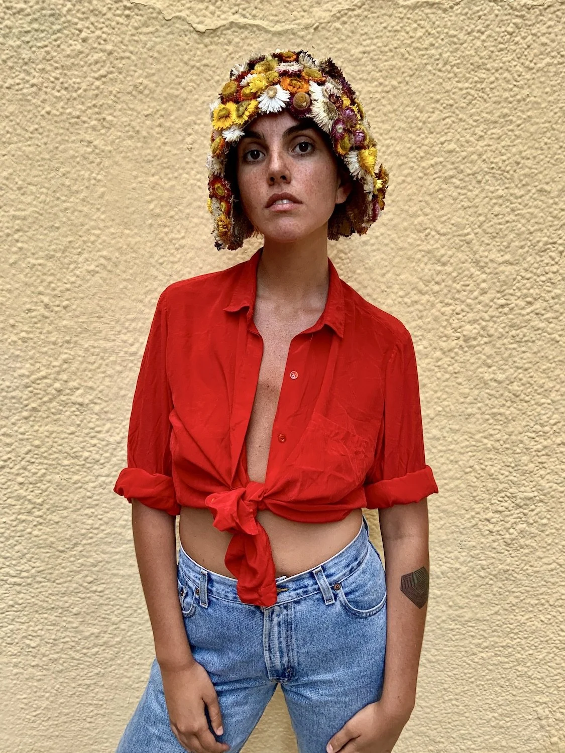 Model wearing fresh flower visor styled by Mosaic Flowers in editorial photoshoot Barcelona
