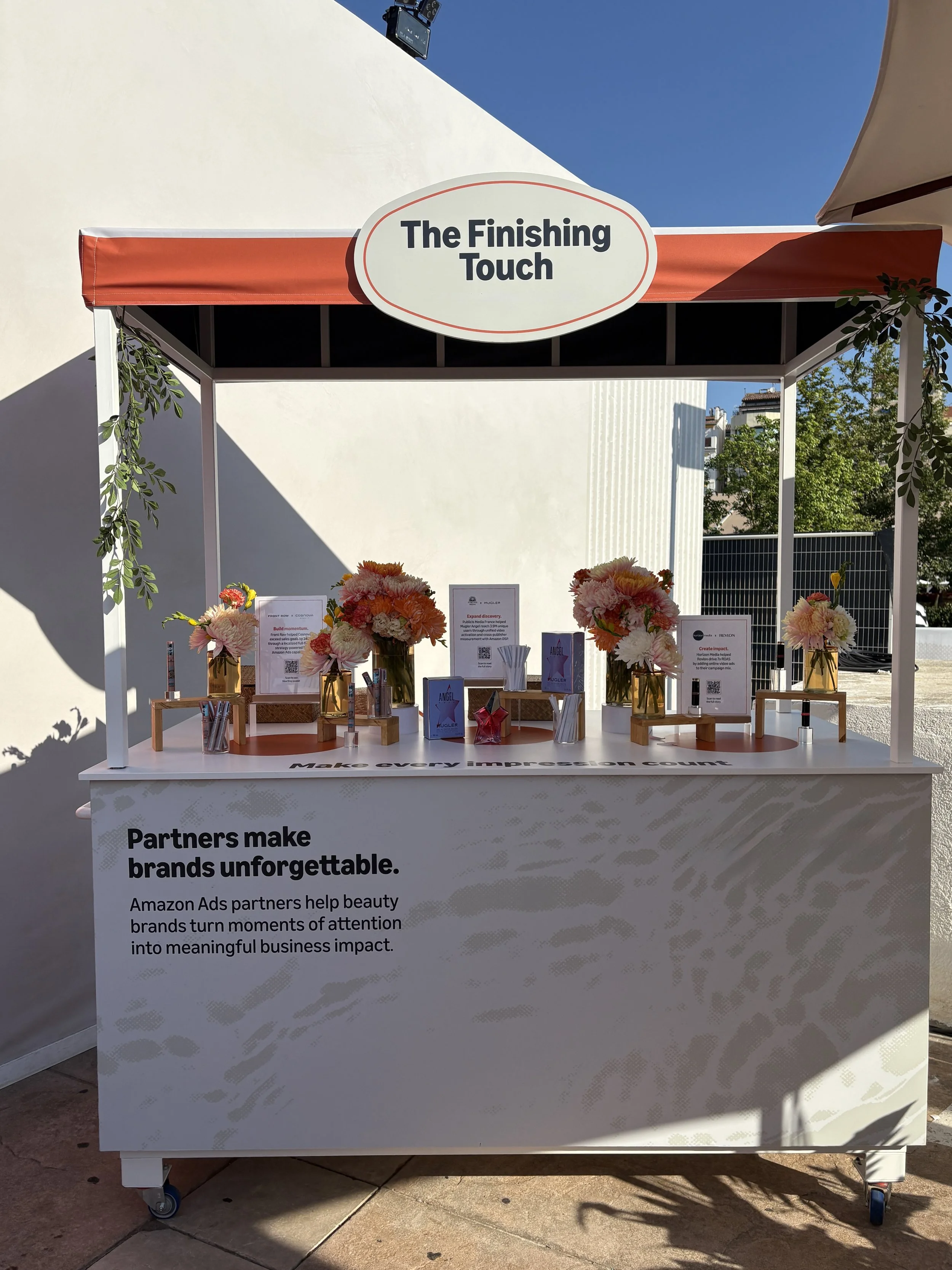 Creative floral installations by Mosaic Flowers decorating a luxury brand activation welcome desk at the Cannes Lions Festival in Cannes