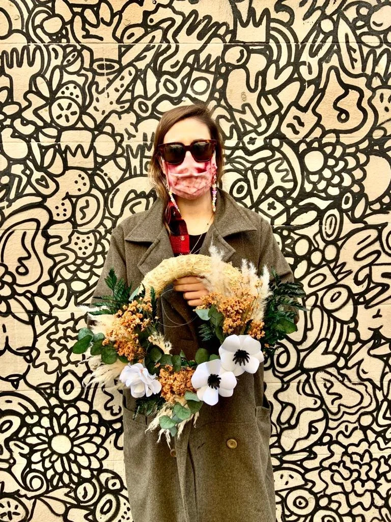 Workshop participant holding wreath with paper and dried flowers created at Mosaic Flowers Barcelona