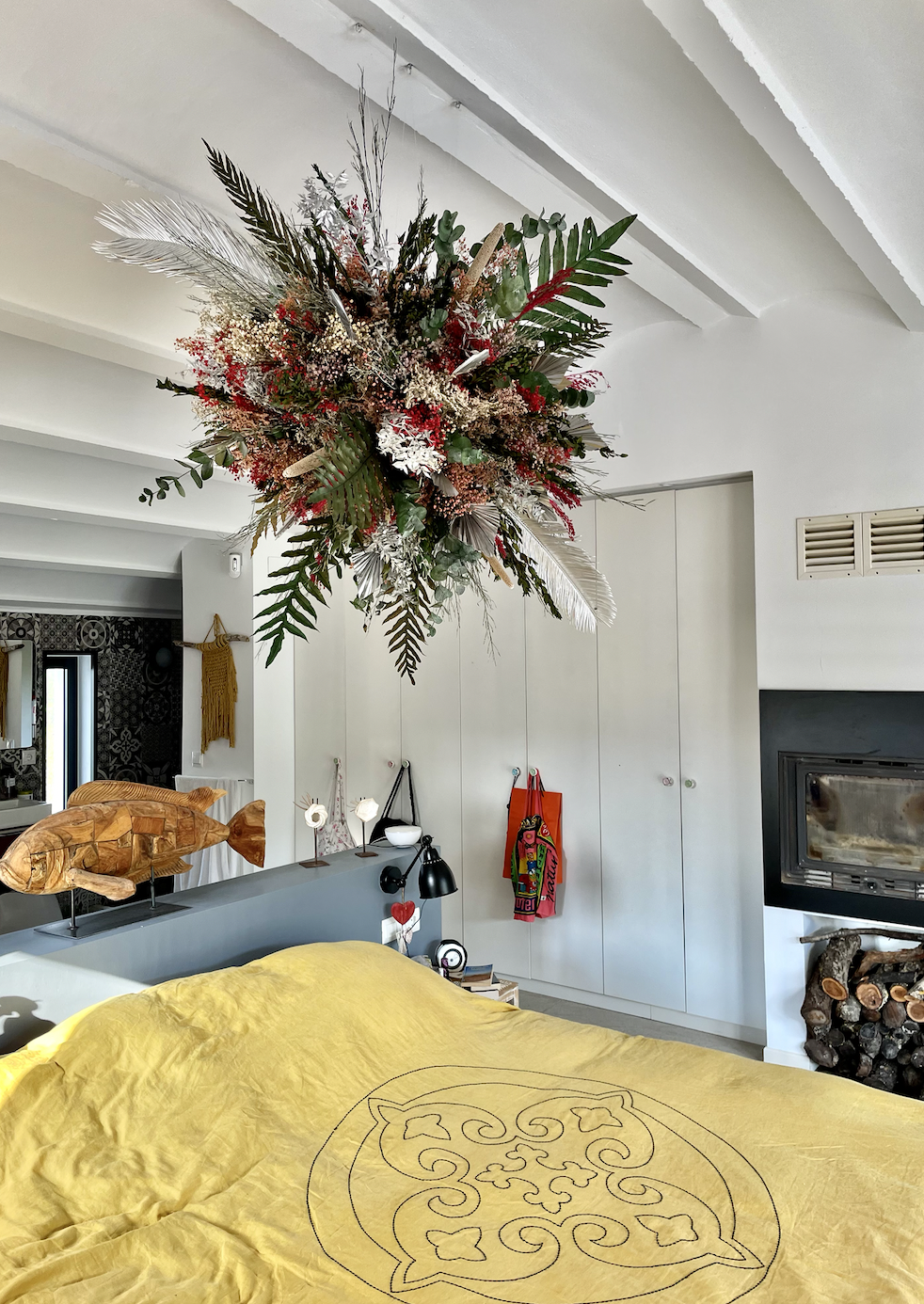 Suspended floral installation with painted preserved flowers hanging from the ceiling of a luxurious house in Barcelona, created by Mosaic