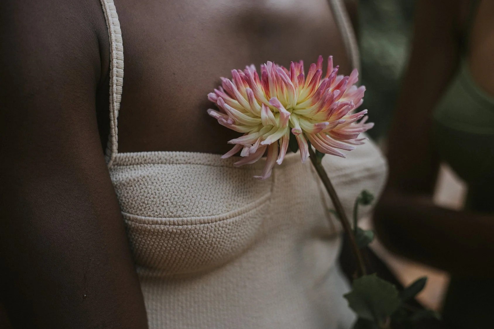 Close-up of dahlia contrasting with Clo Stories bathing suit, Mosaic Flowers editorial floral styling in Barcelona