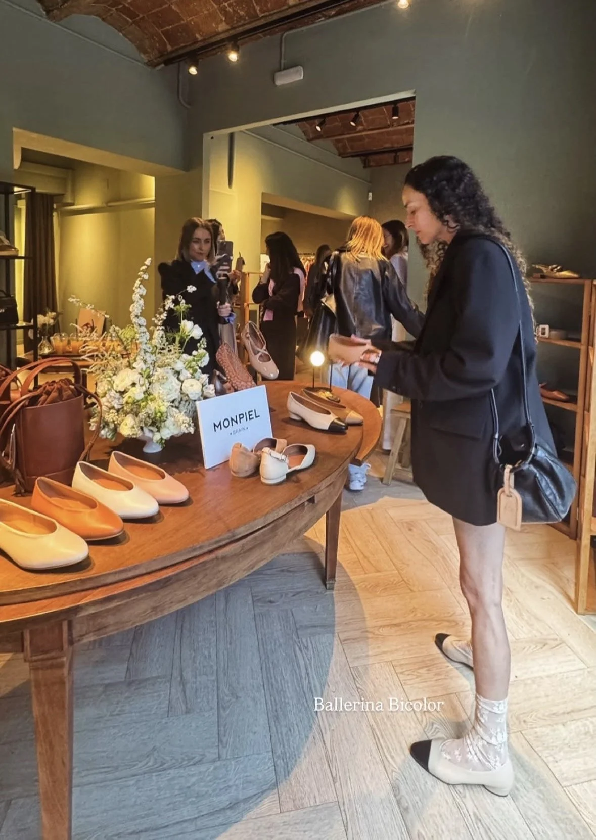 Guests enjoying the Monpiel PR event surrounded by sophisticated white floral arrangements designed by Mosaic Flowers for a luxury brand experience at Portico Concept
