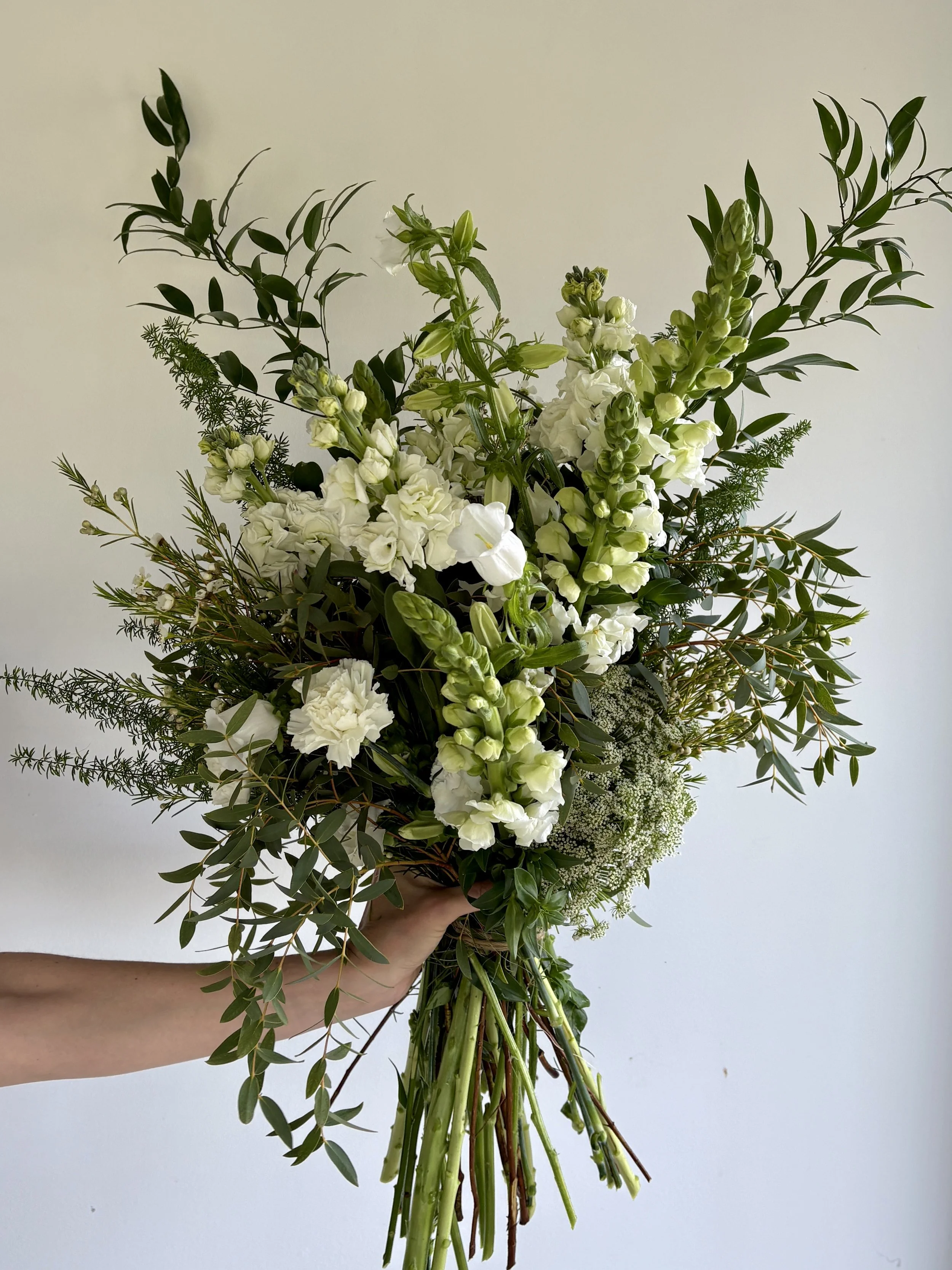 Premium luxury floral composition for VIP gifting in Barcelona, showcasing refined white seasonal flowers and lush foliage with exceptional attention to detail