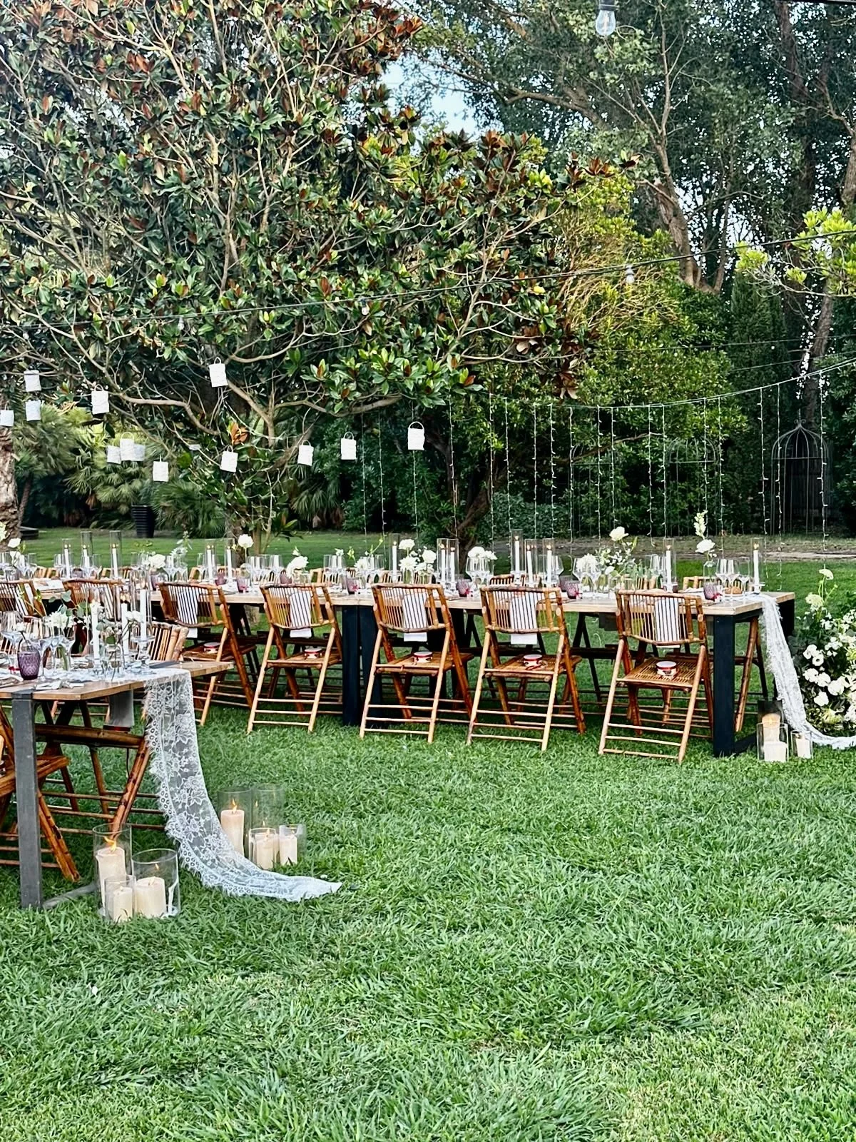 A panoramic view of Mosaic’s floral installation for Megan and Shane’s wedding, creating a sophisticated garden dining experience surrounded by lush Mediterranean planting at Cortal Gran
