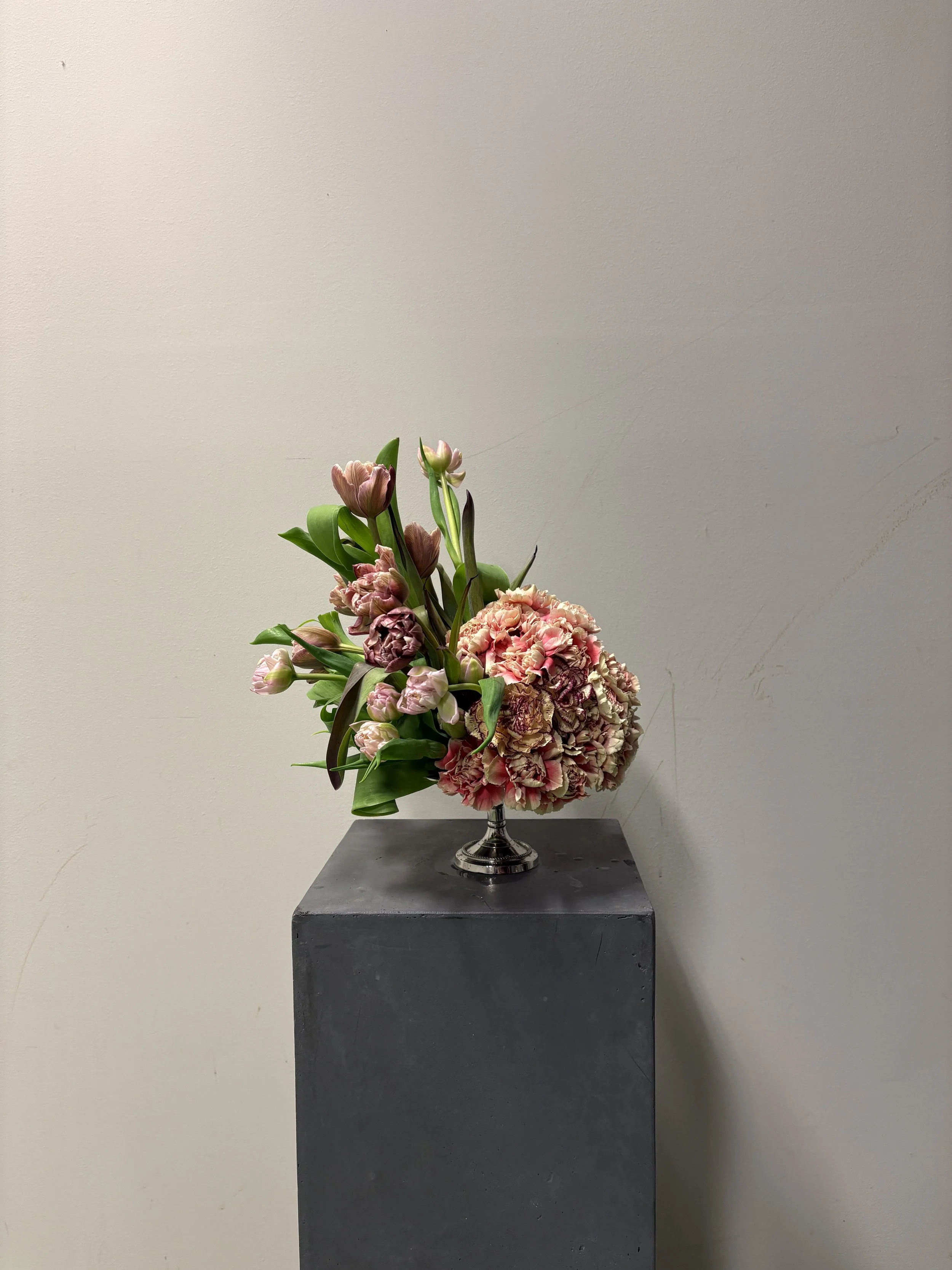 Artistic floral composition combining seasonal blooms and sculptural forms created for the luxury wedding of Christie and Andrew at Villa Almanita