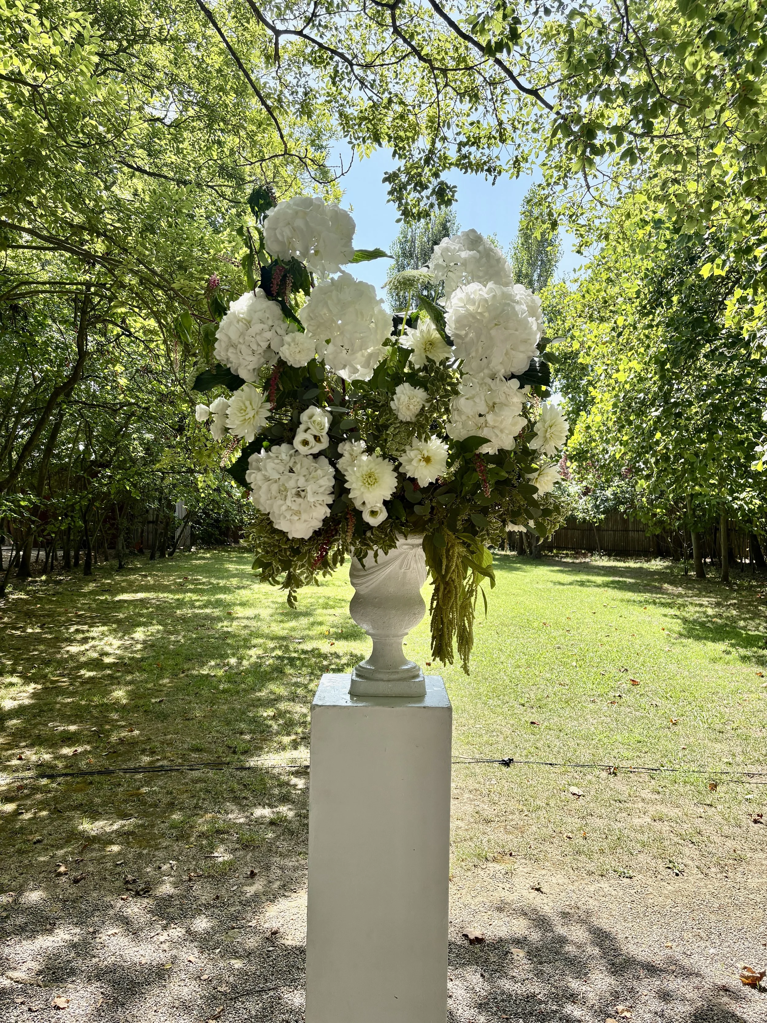 Sculptural white floral arrangement designed by Mosaic for Megan and Shane’s wedding at Cortal Gran, featuring abundant hydrangeas and refined botanical textures in an elegant luxury setting