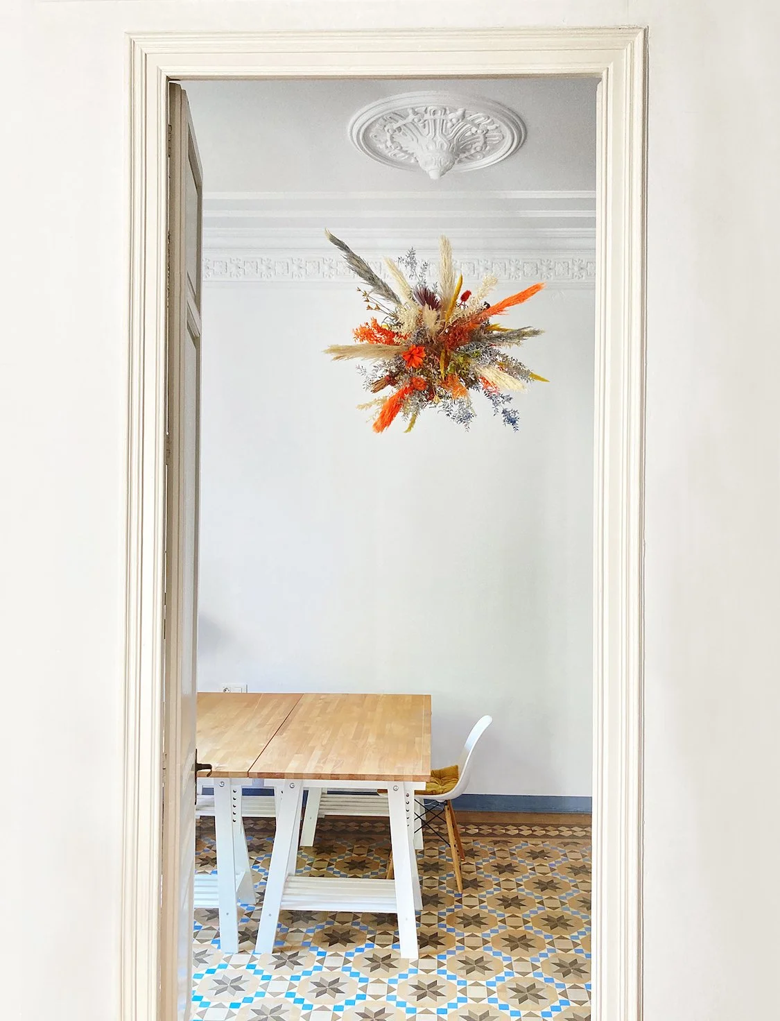 Luxury Eixample flat in Barcelona featuring a warm-colored suspended floral installation by Mosaic for international brand clients