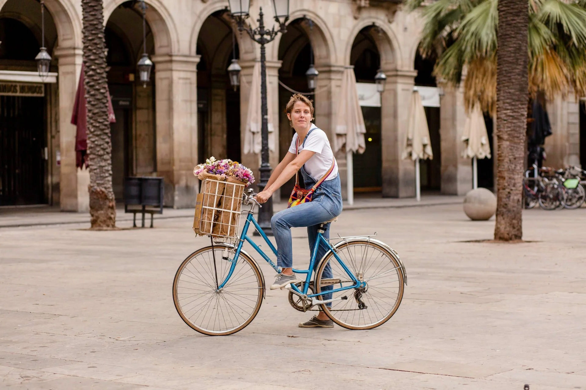 Floral designer Margaux Bastid selecting fresh blooms in the Barcelona flower market for destination events and luxury creations