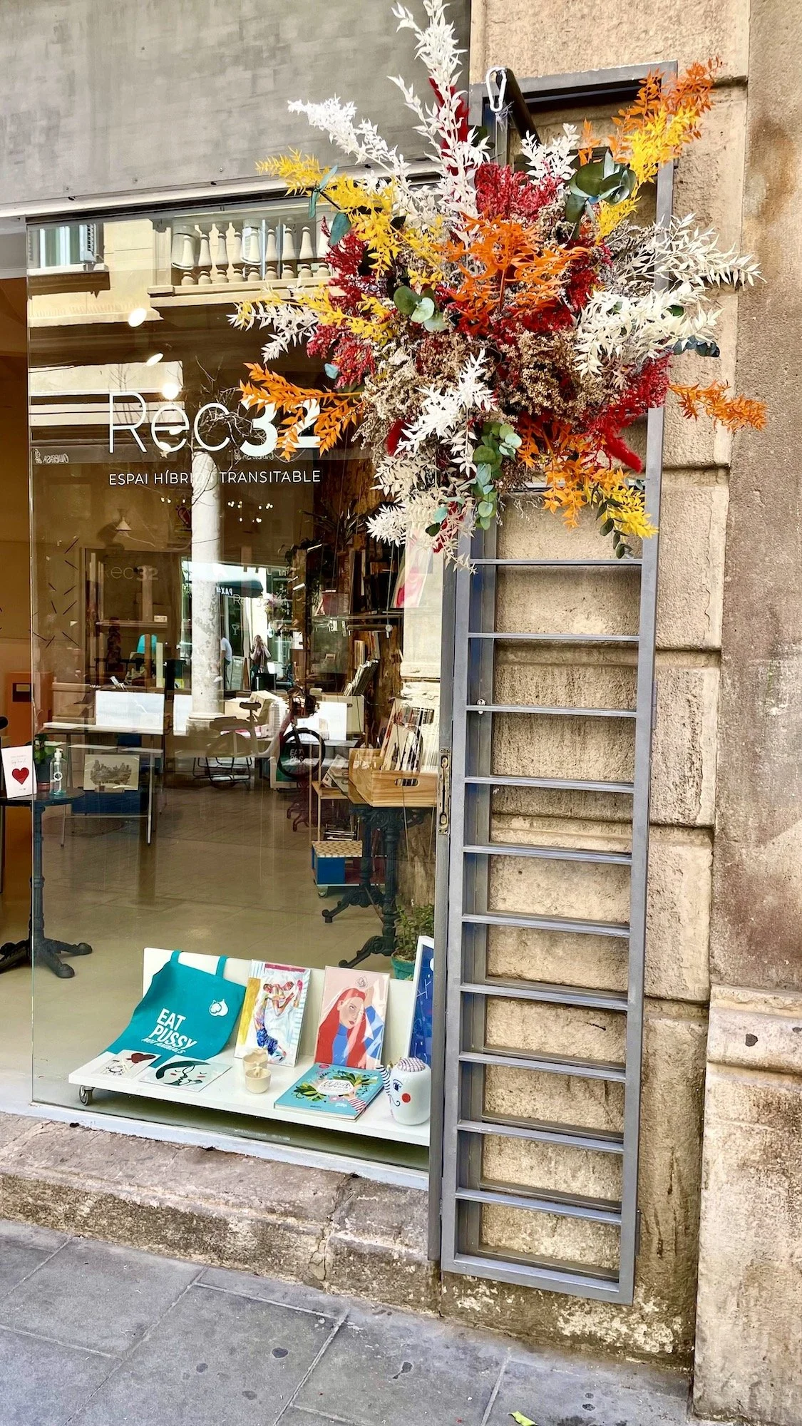 Floating flower installation by Mosaic displayed at art gallery window in Barcelona