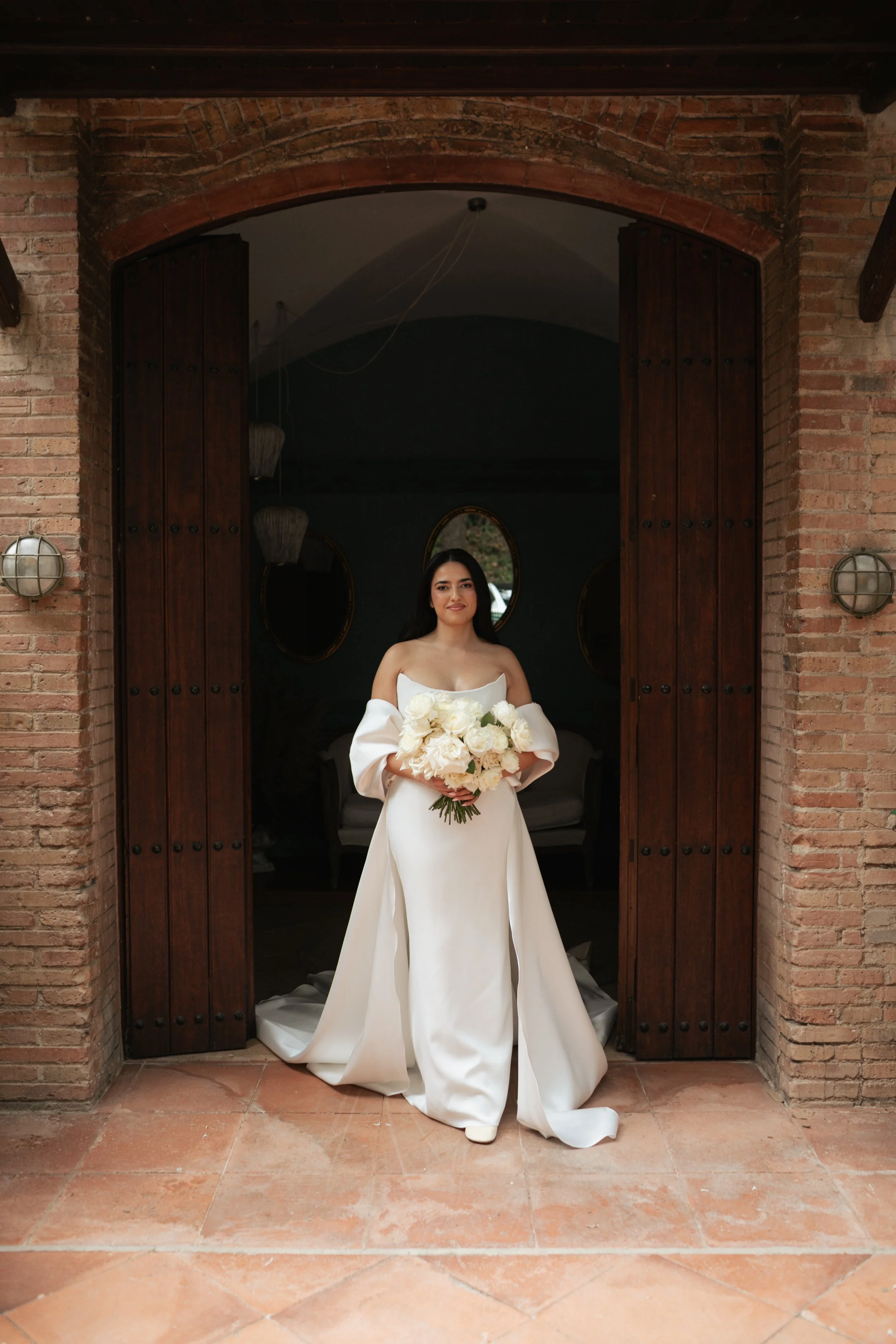Bride portrait featuring a bespoke floral bouquet by Mosaic, designed to complement a contemporary and refined bridal look