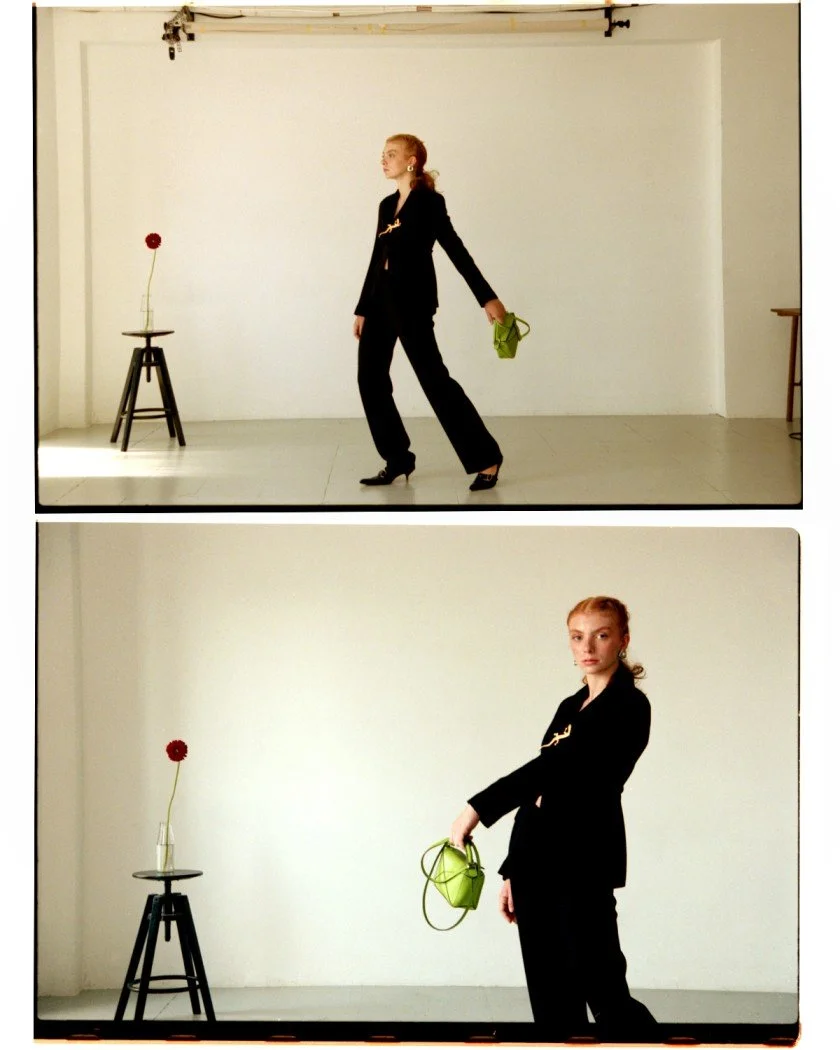 Model in a black outfit posing with flowers for an editorial fashion photoshoot styled by Mosaic in Barcelona