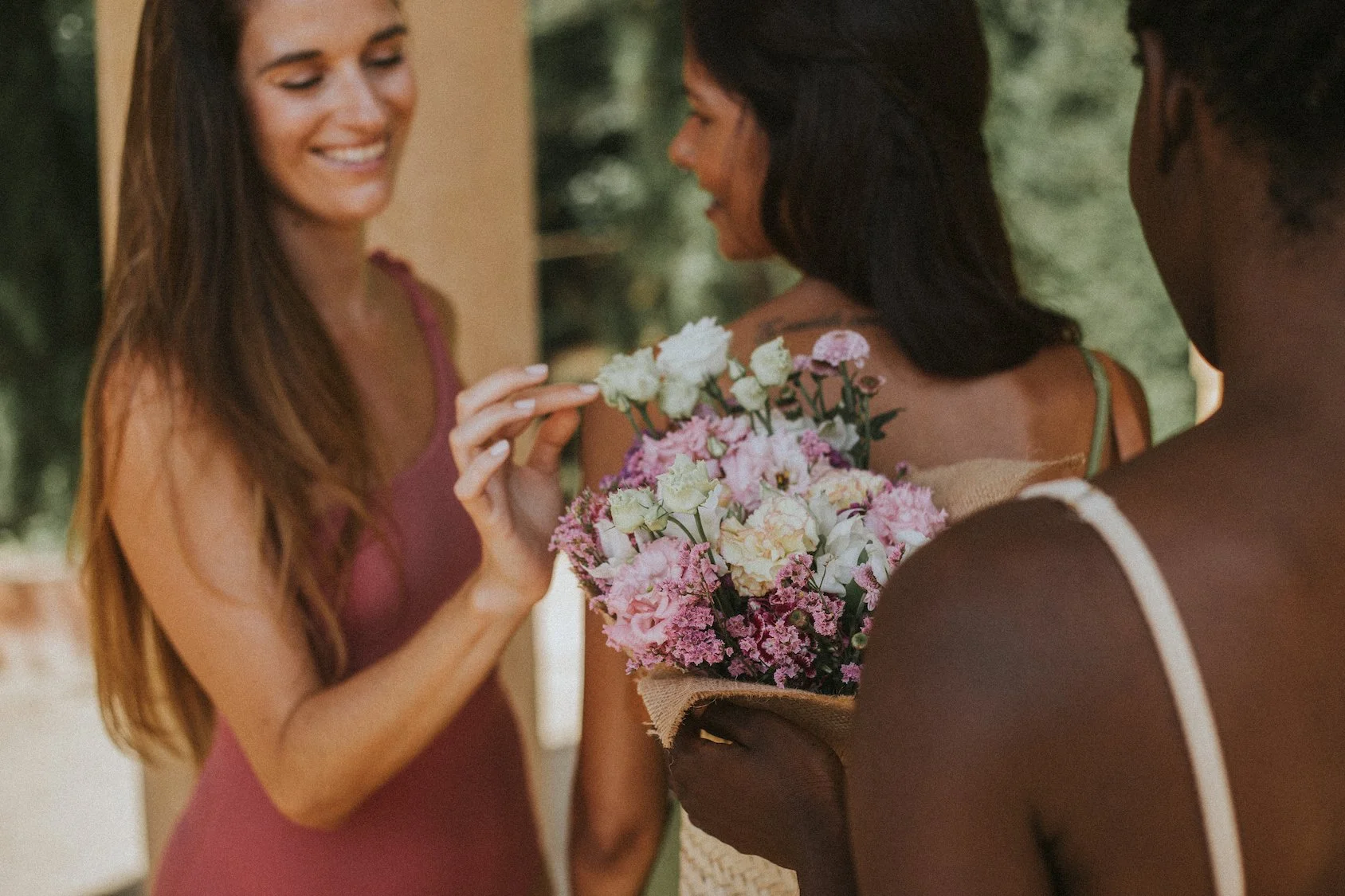 Model holding bouquet of pink flowers by Mosaic Flowers during editorial photoshoot in Horta park Barcelona