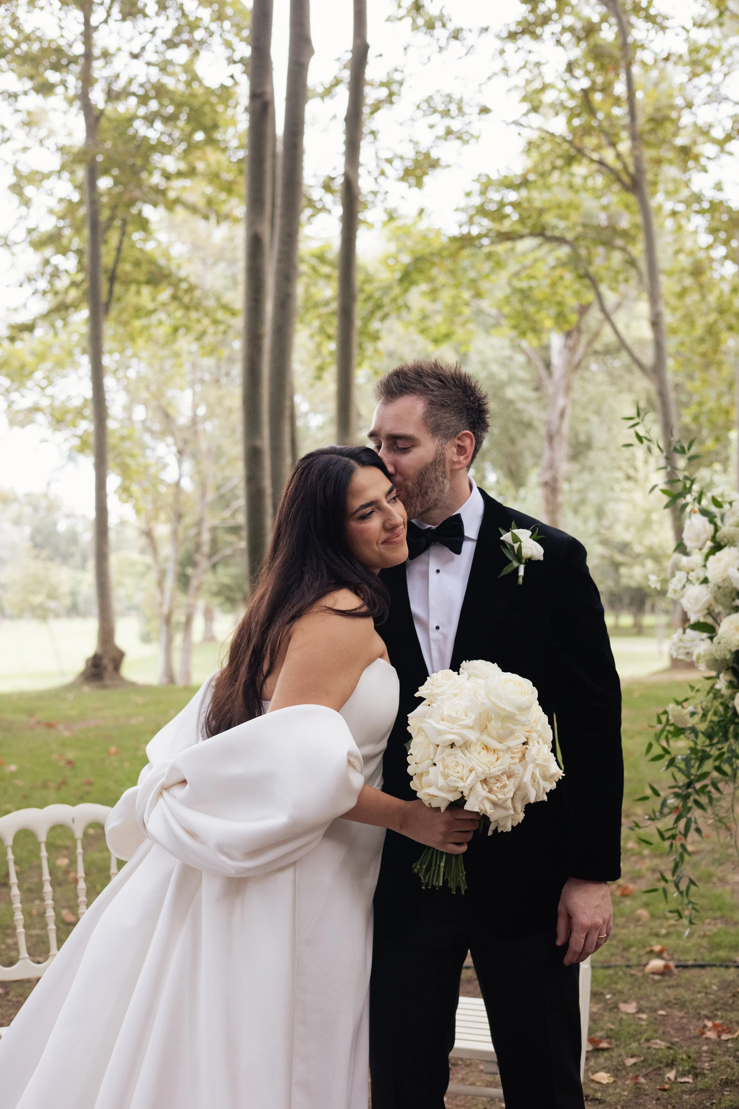 Romantic wedding moment framed by bespoke floral design by Mosaic, highlighting a soft, refined palette for a luxury celebration