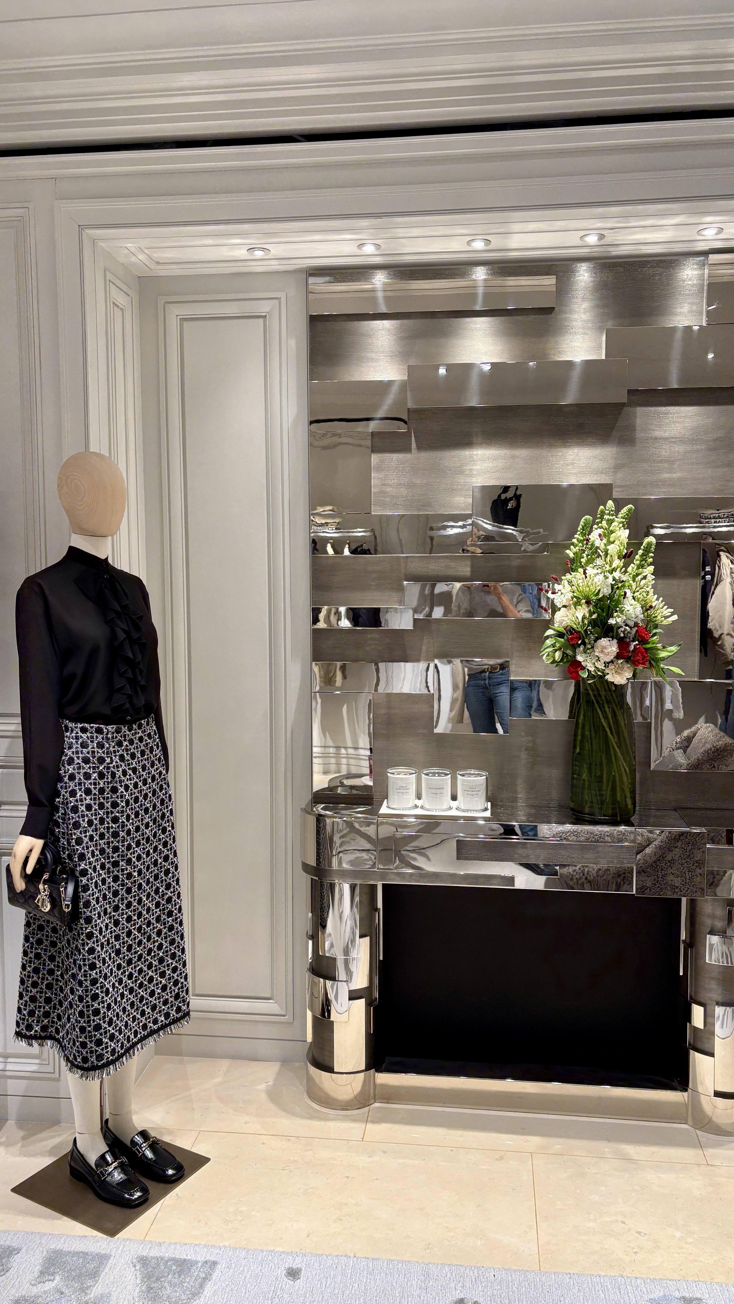 Luxury floral arrangement displayed in an elegant retail space, complementing the Spring Summer 2027 flagship boutique presentation