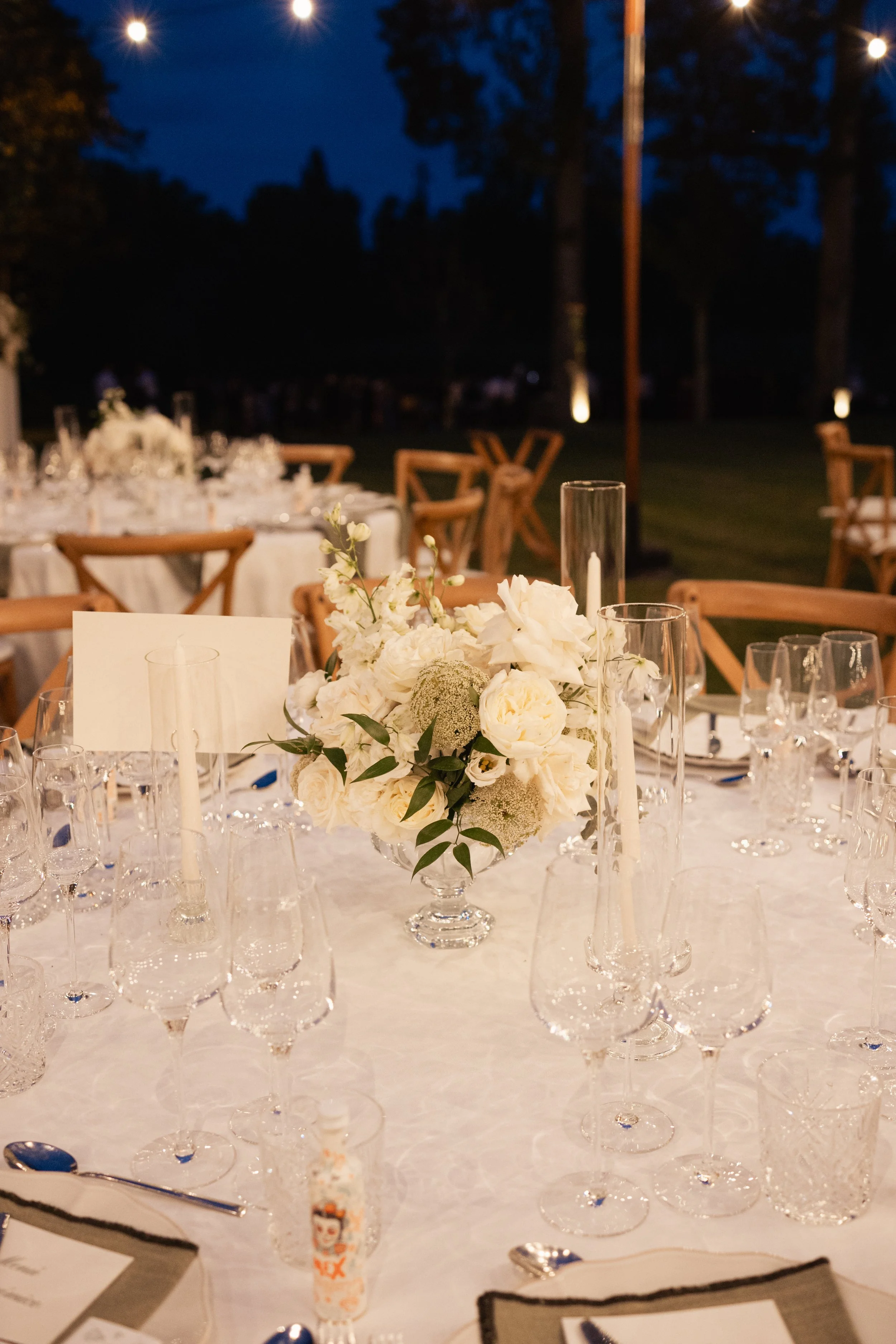 Outdoor wedding ceremony enhanced by minimalist floral installations by Mosaic, blending natural surroundings with high-end floral design