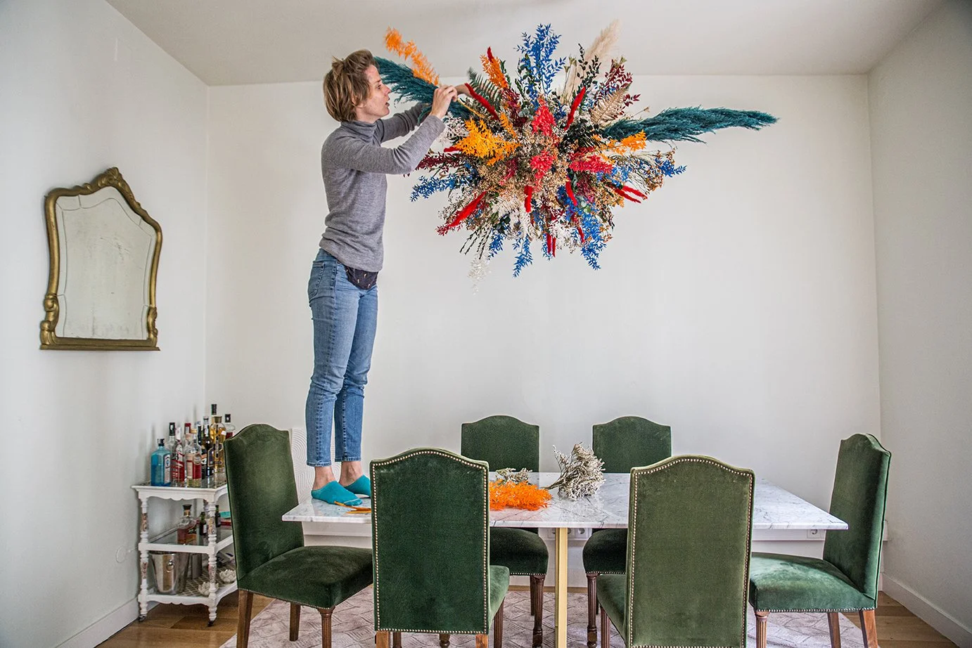 Margaux installing luxury floating floral sculpture with preserved flowers in Barcelona flat