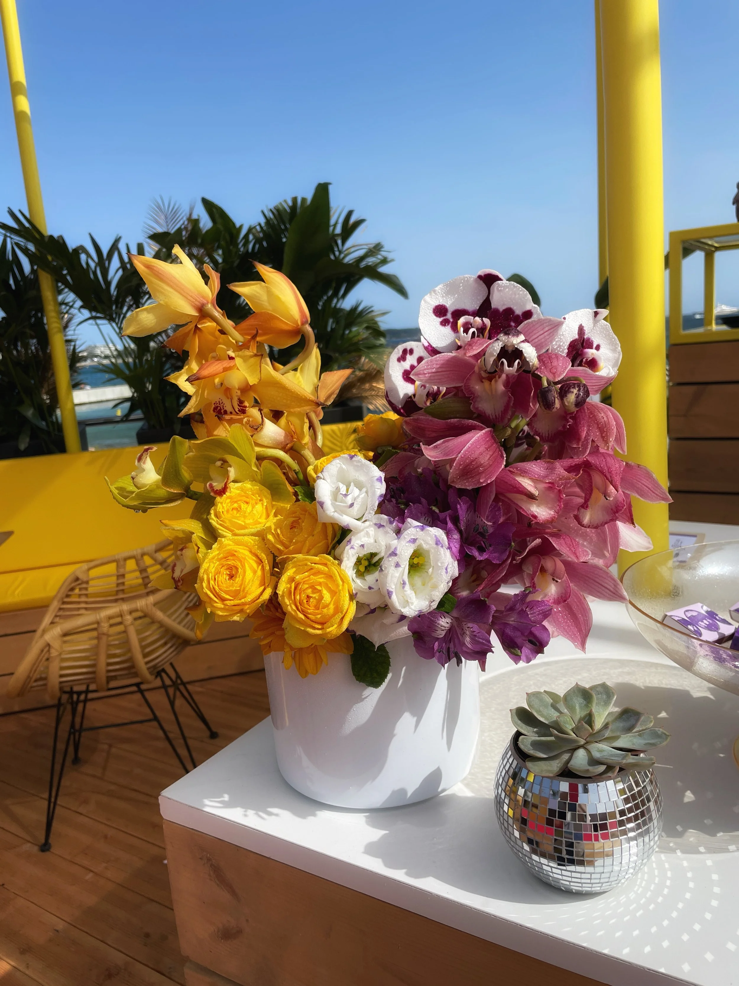 Refined floral table styling by Mosaic for Tubi at Cannes Lions 2024, combining bespoke arrangements and natural elements to elevate the guest experience in a luxury brand setting