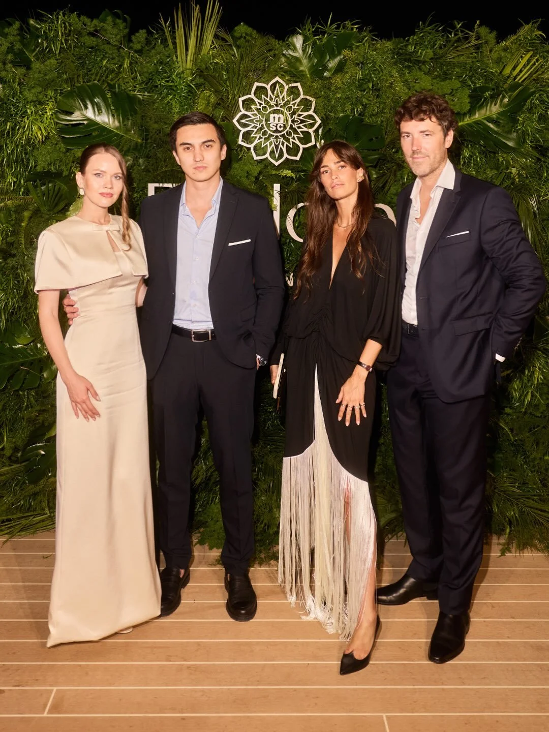 VIP guests posing in front of Mosaic's luxury botanical backdrop during the Explora III inauguration